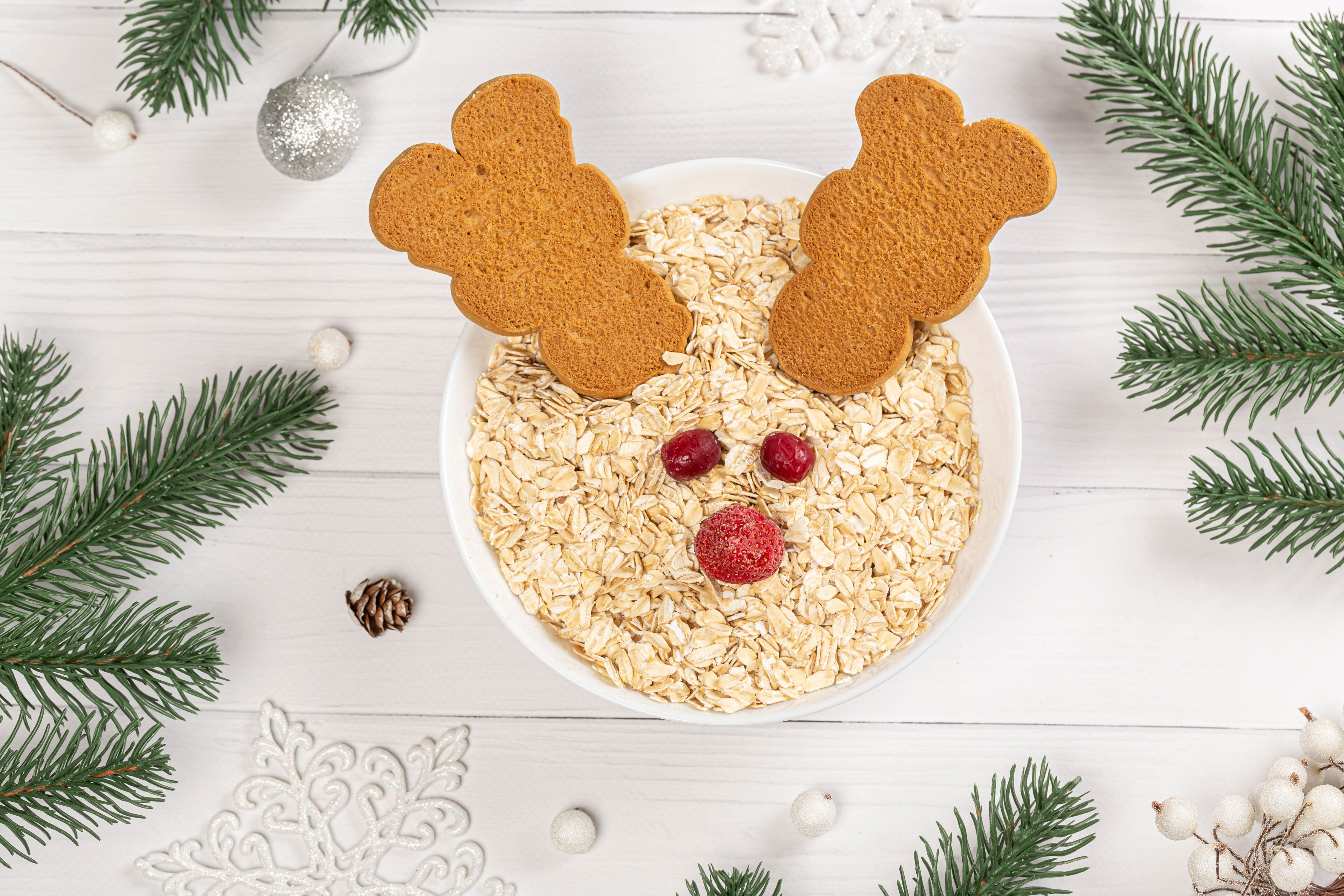 Christmas reindeer oatmeal with cookies and pine branches HD Wallpaper