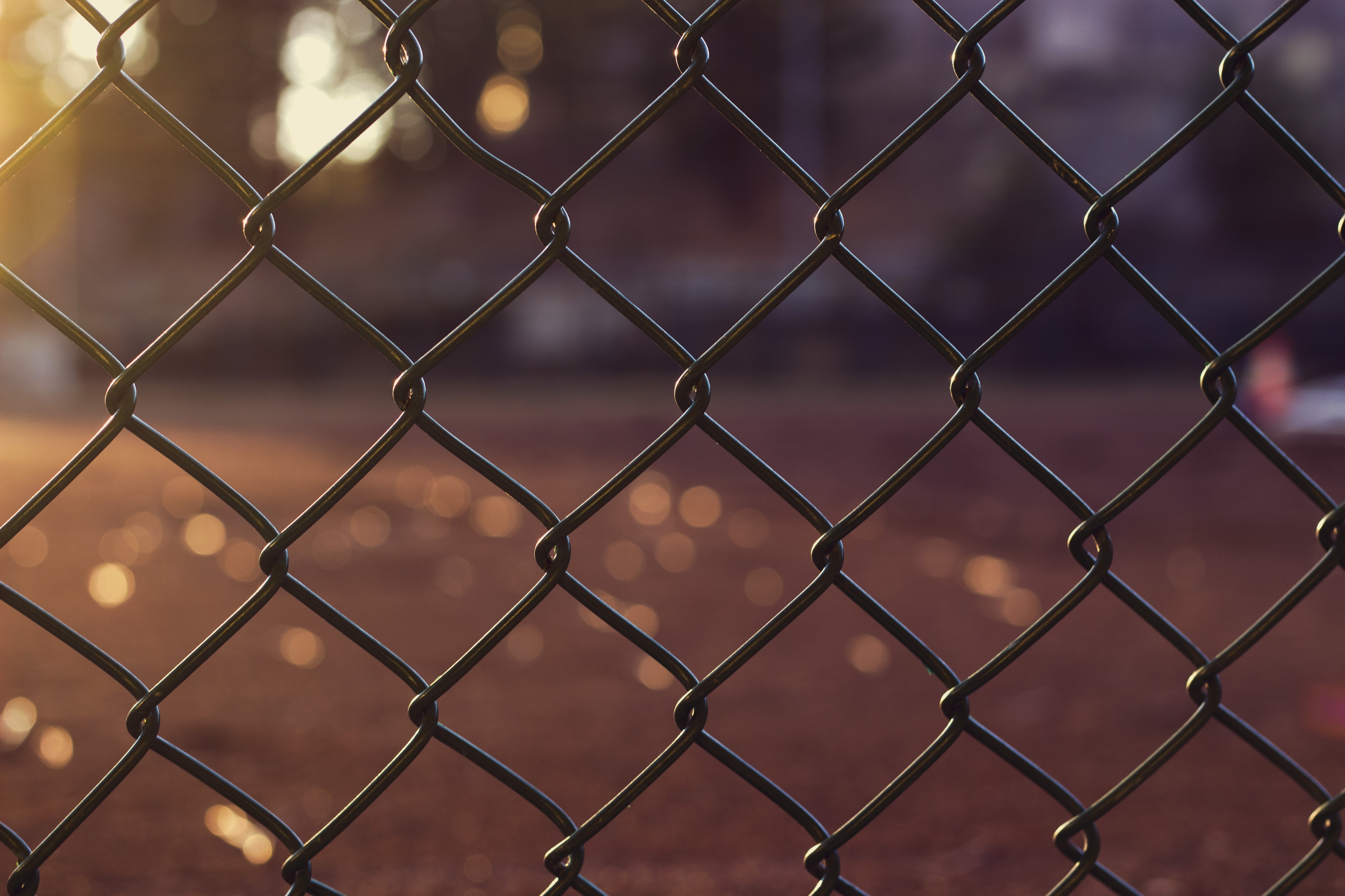 Chain-link fence with bokeh background HD Wallpaper