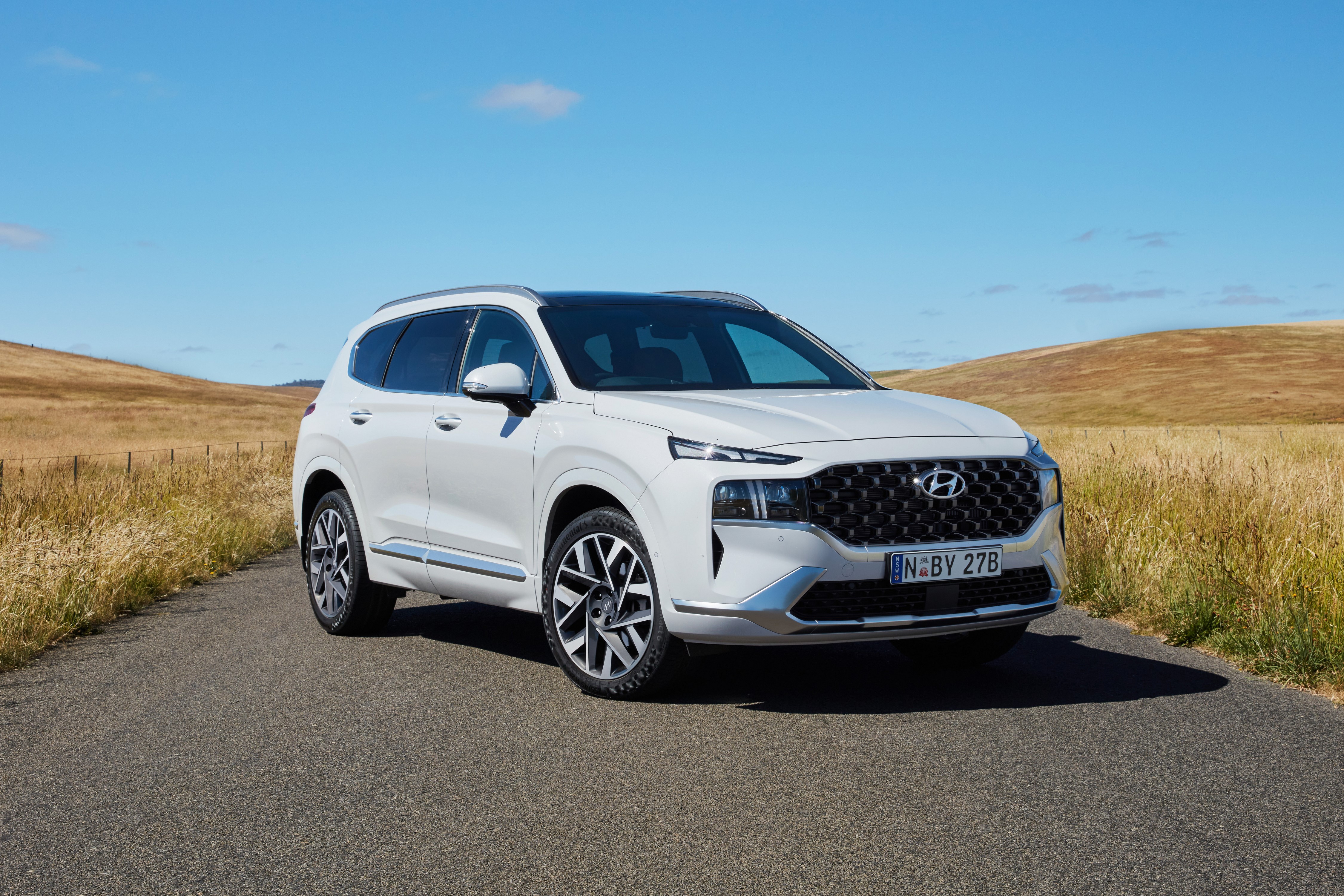 White Hyundai Santa Fe Highlander on a road HD Wallpaper