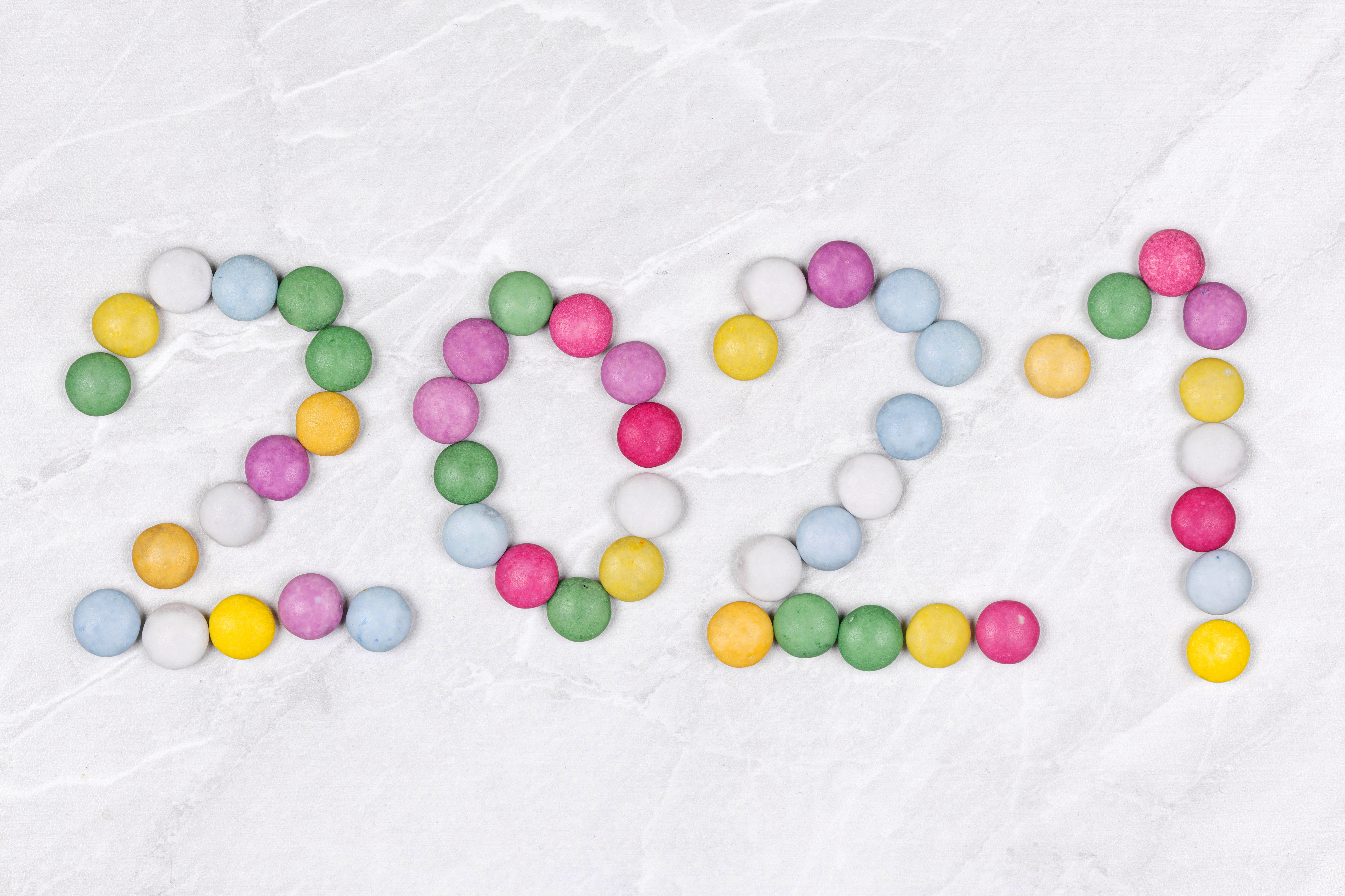 2021 made of colorful candies on a marble background HD Wallpaper