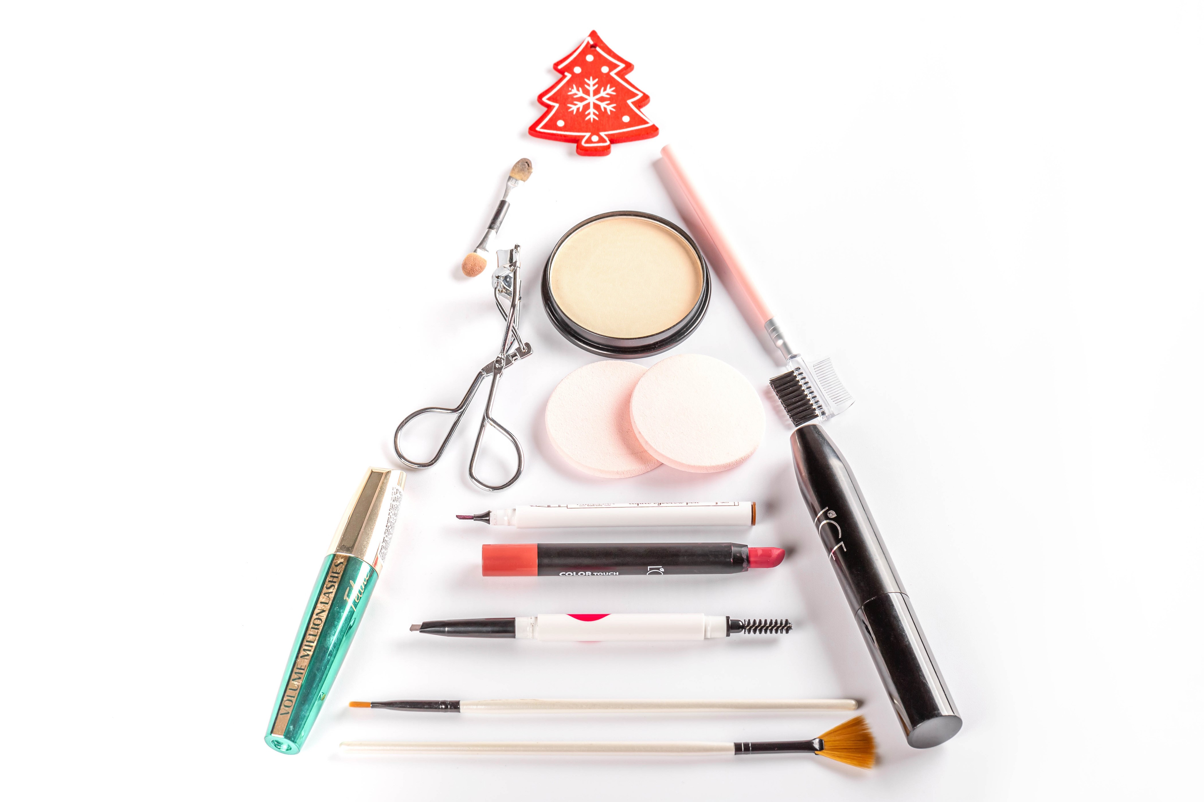 Christmas tree made of cosmetics on white background HD Wallpaper