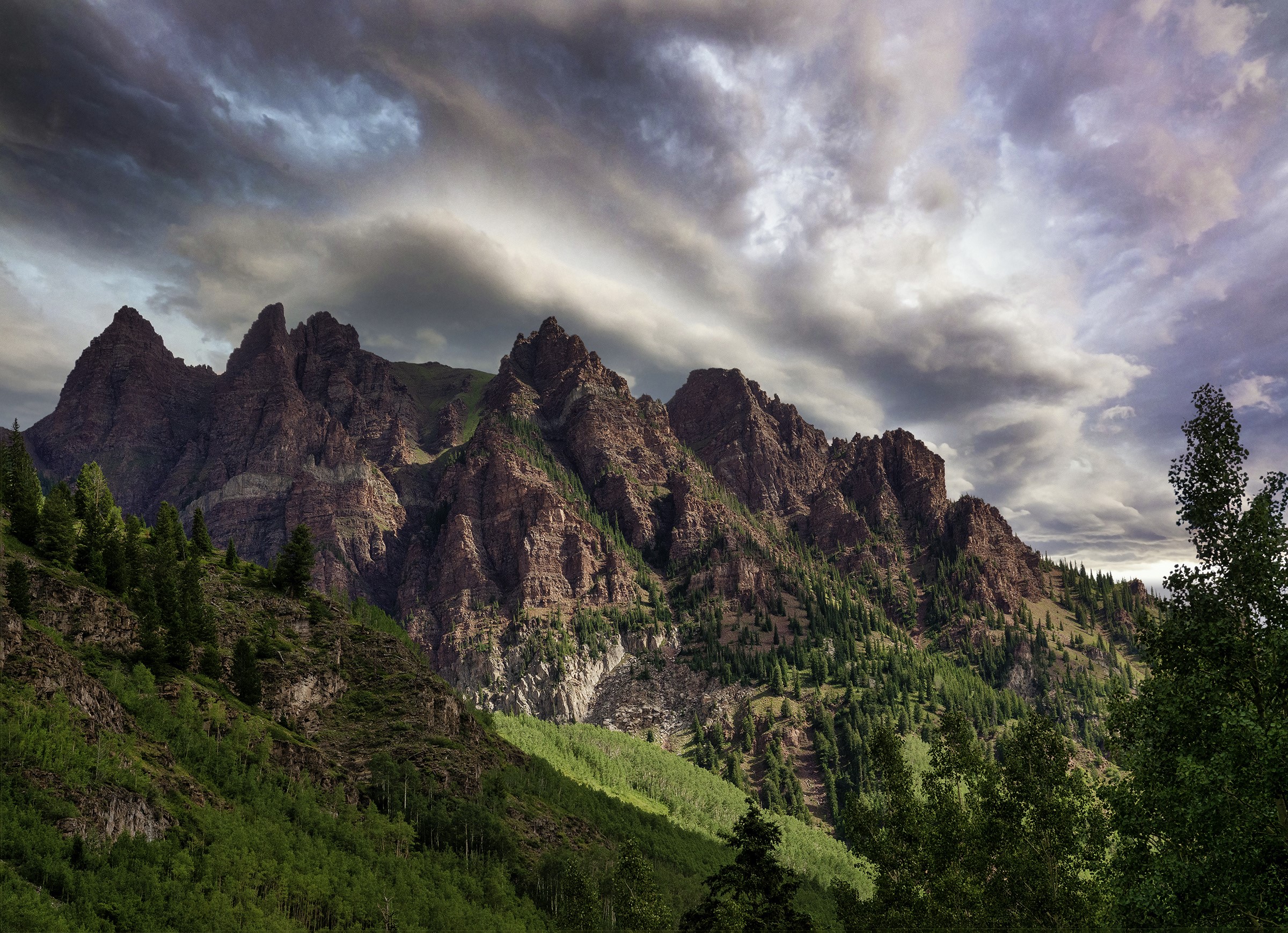 Jagged mountain range with dramatic clouds in Sievers Mountain, Colorado HD Wallpaper