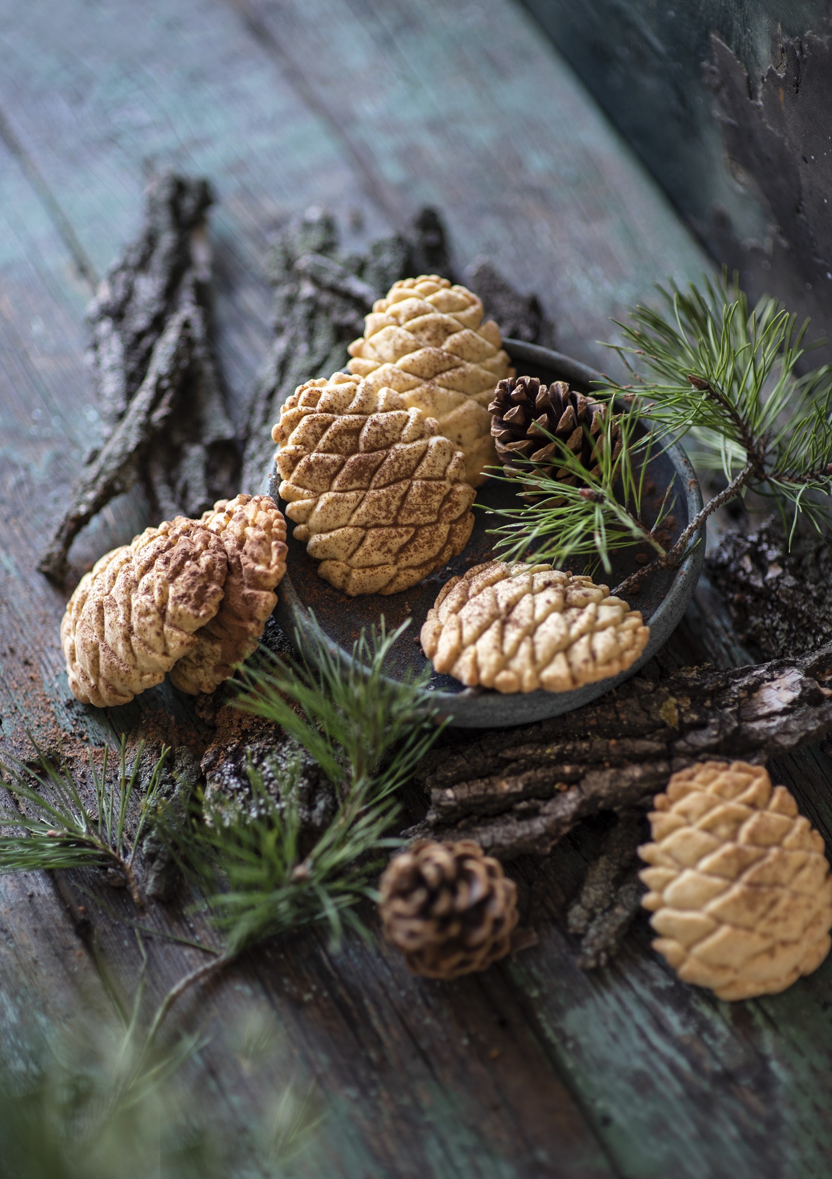Pine cone cookies on rustic wooden surface with pine branches HD Phone Wallpaper
