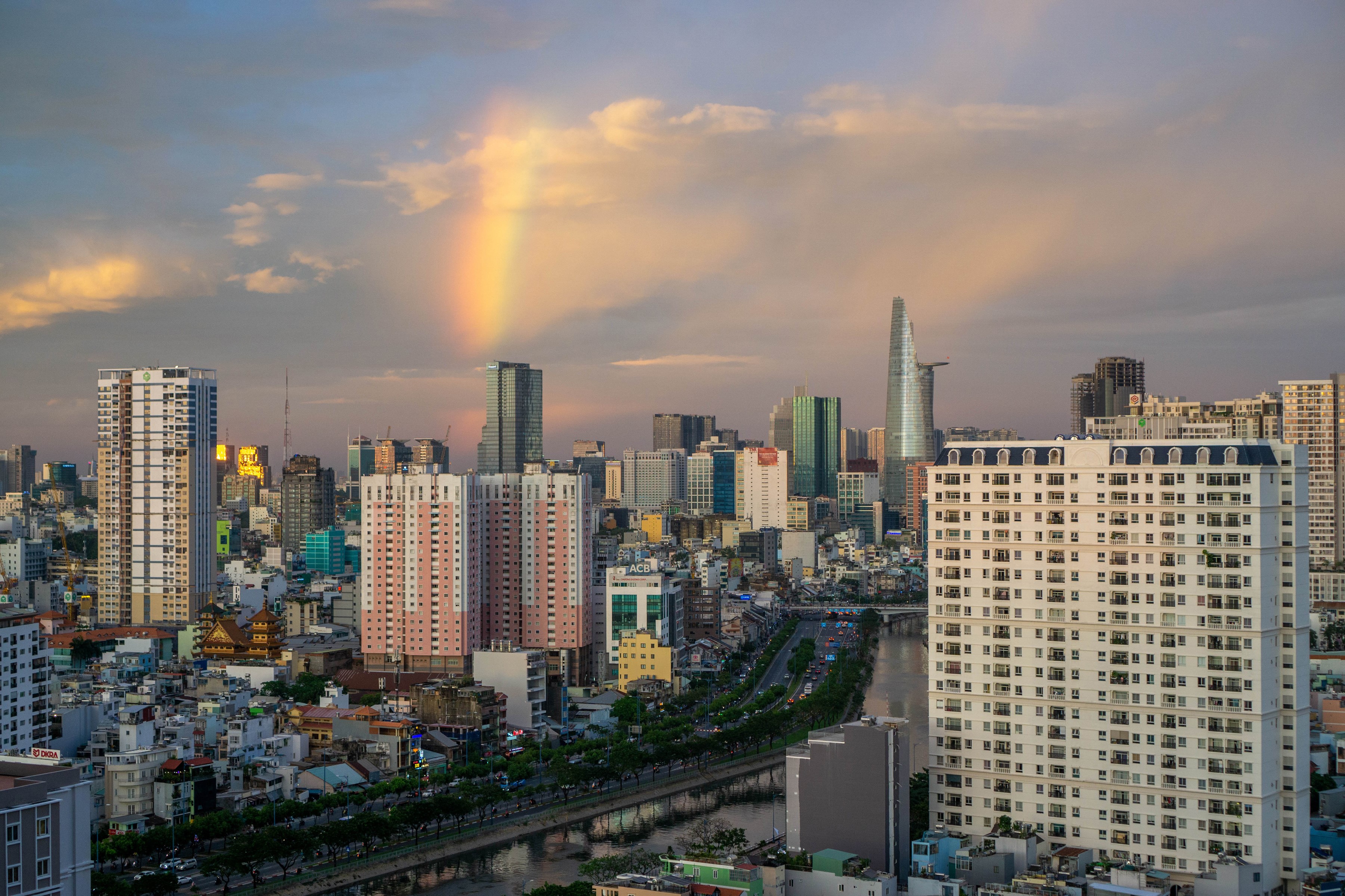 Ho Chi Minh City skyline with rainbow over river HD Wallpaper