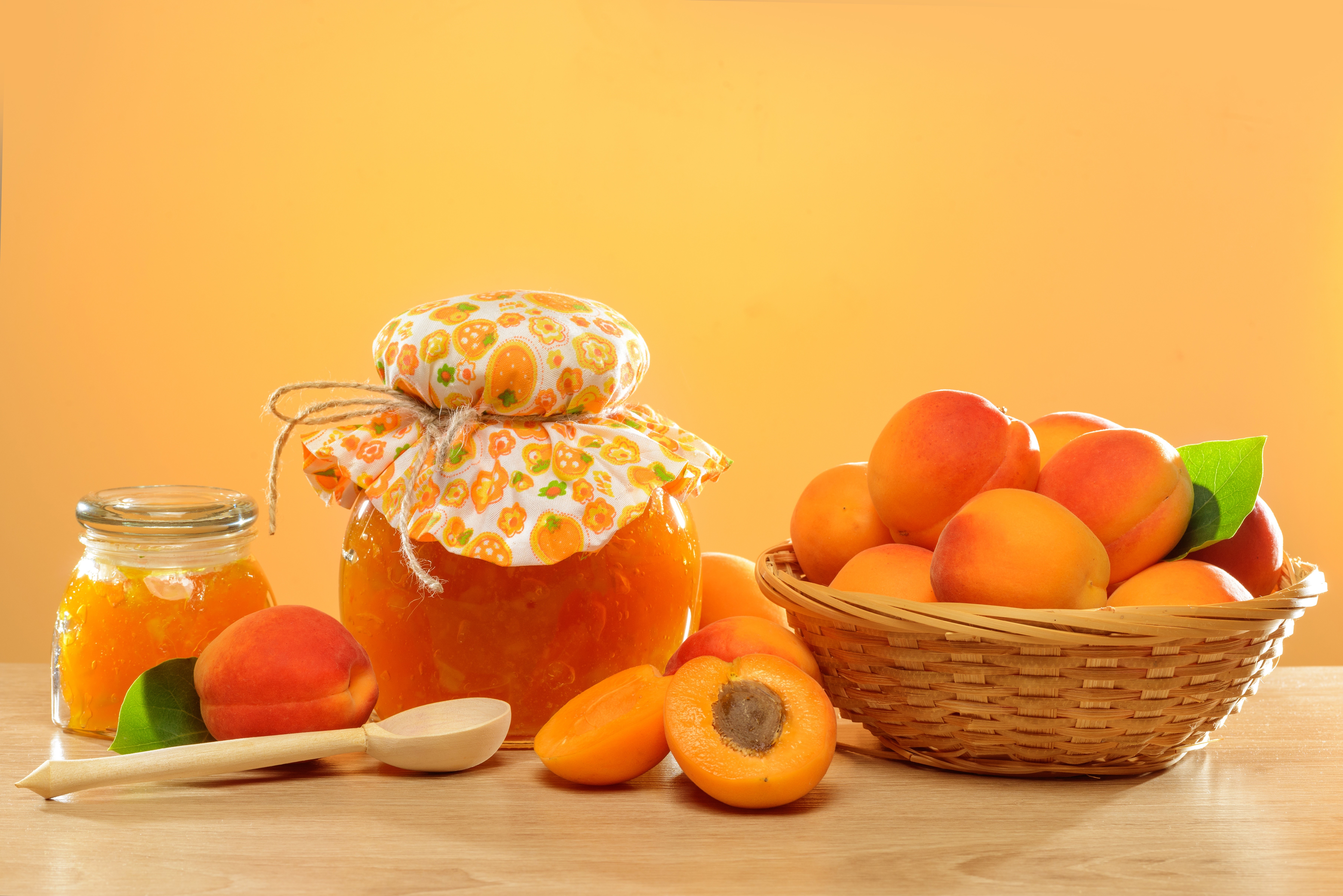 Apricot jam in jars and wicker basket with apricots HD Wallpaper