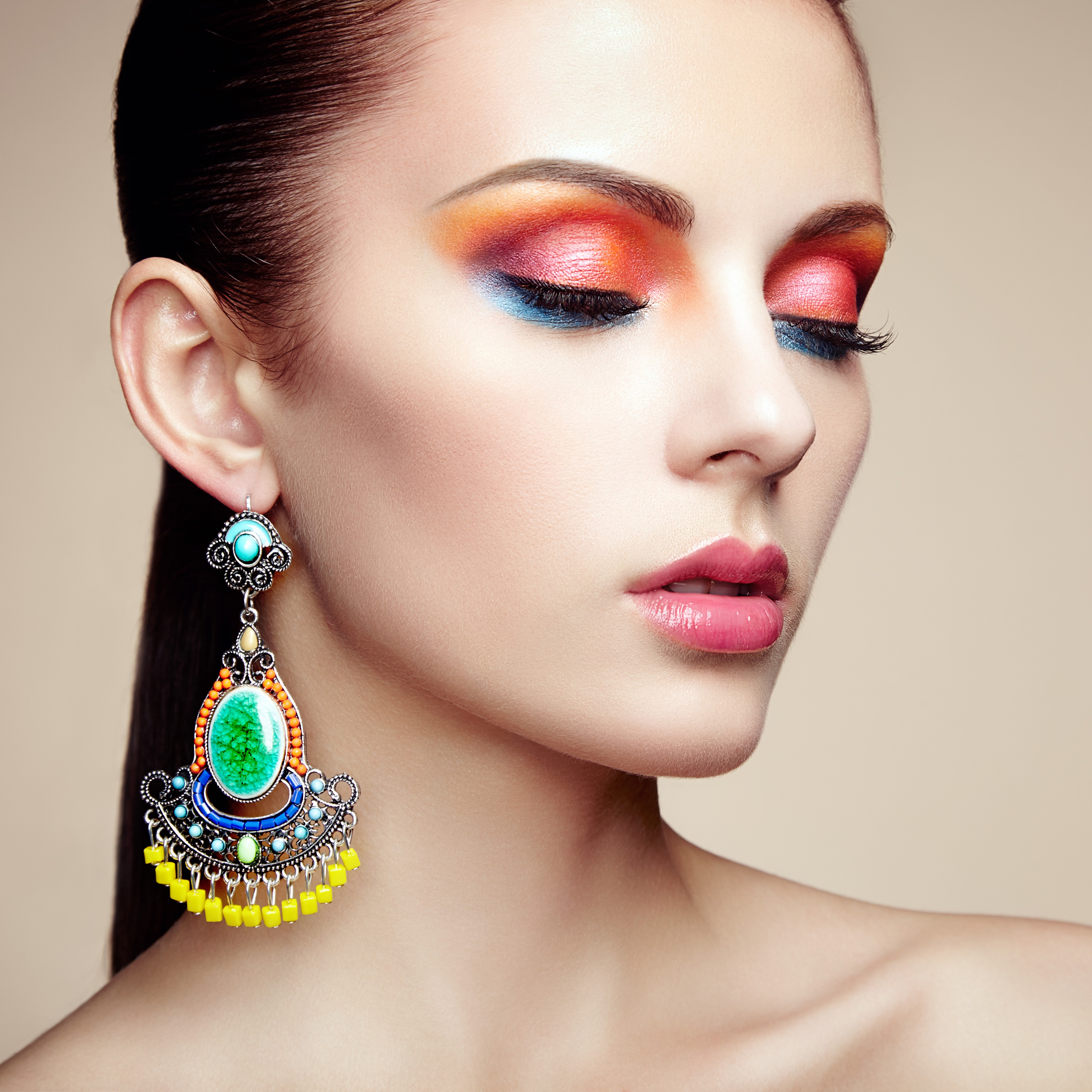 Woman with colorful makeup and large earrings HD Wallpaper