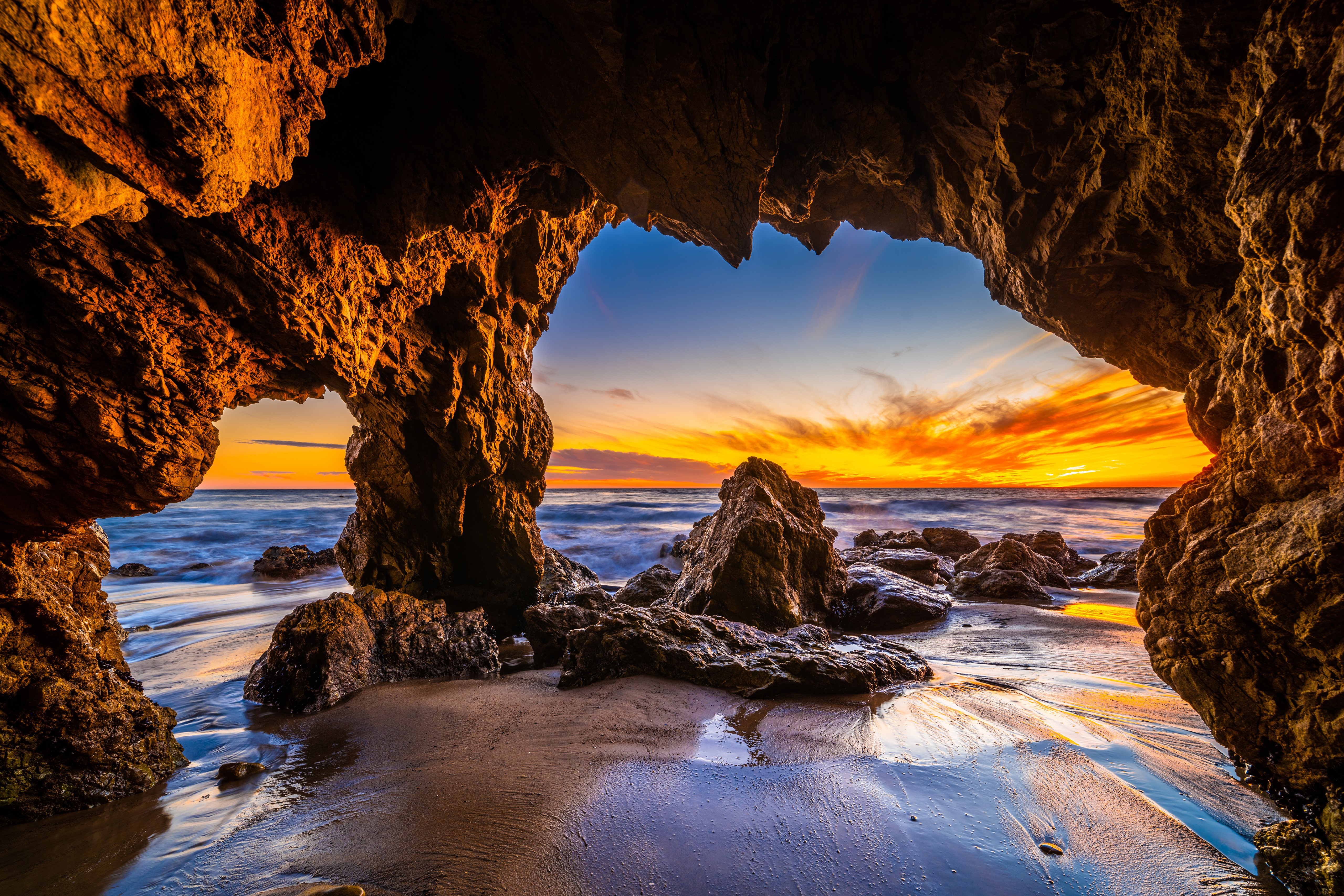 Sunset through a cave at El Matador Beach, California HD Wallpaper