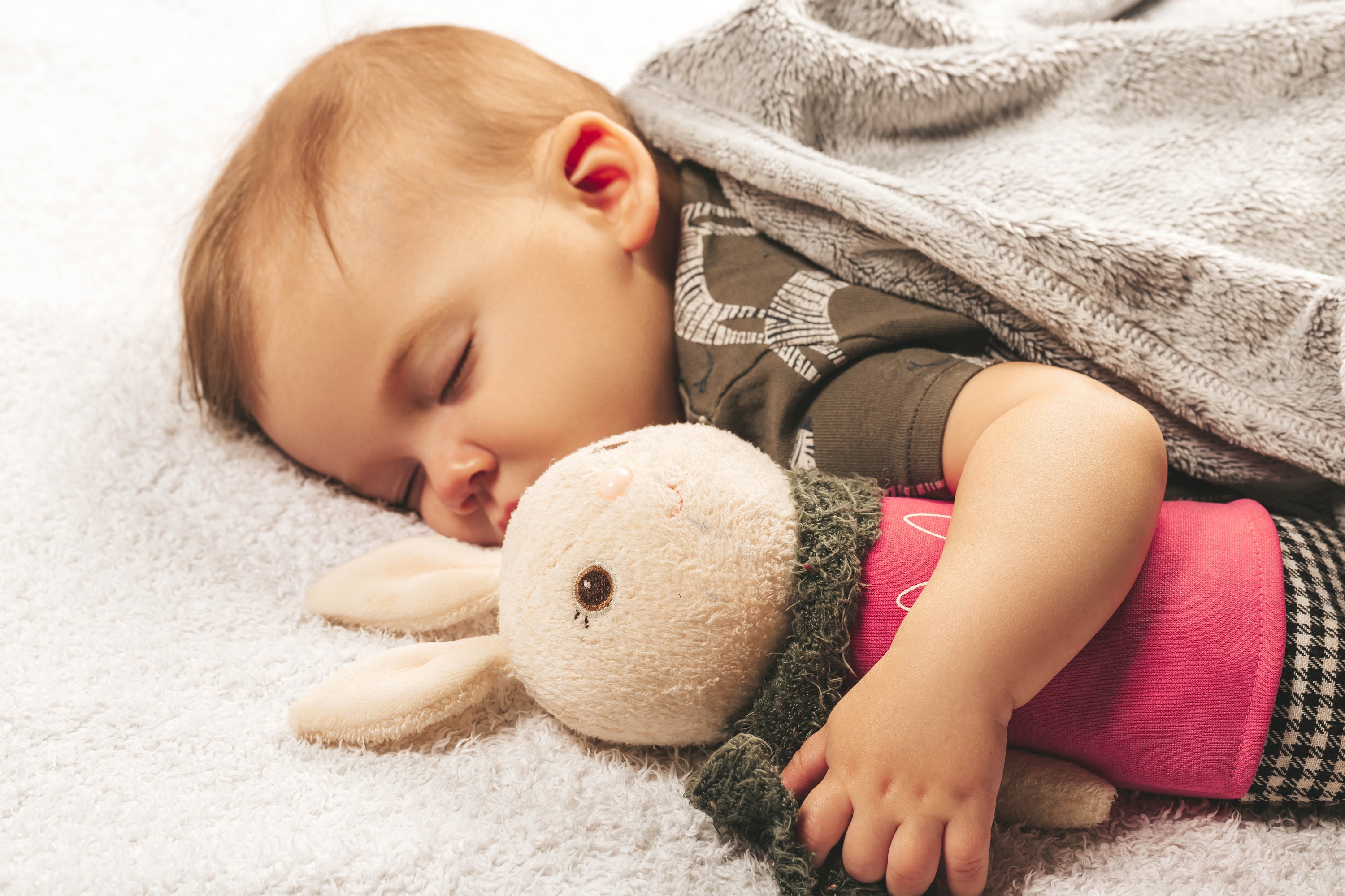 Baby sleeping with a stuffed bunny toy HD Wallpaper