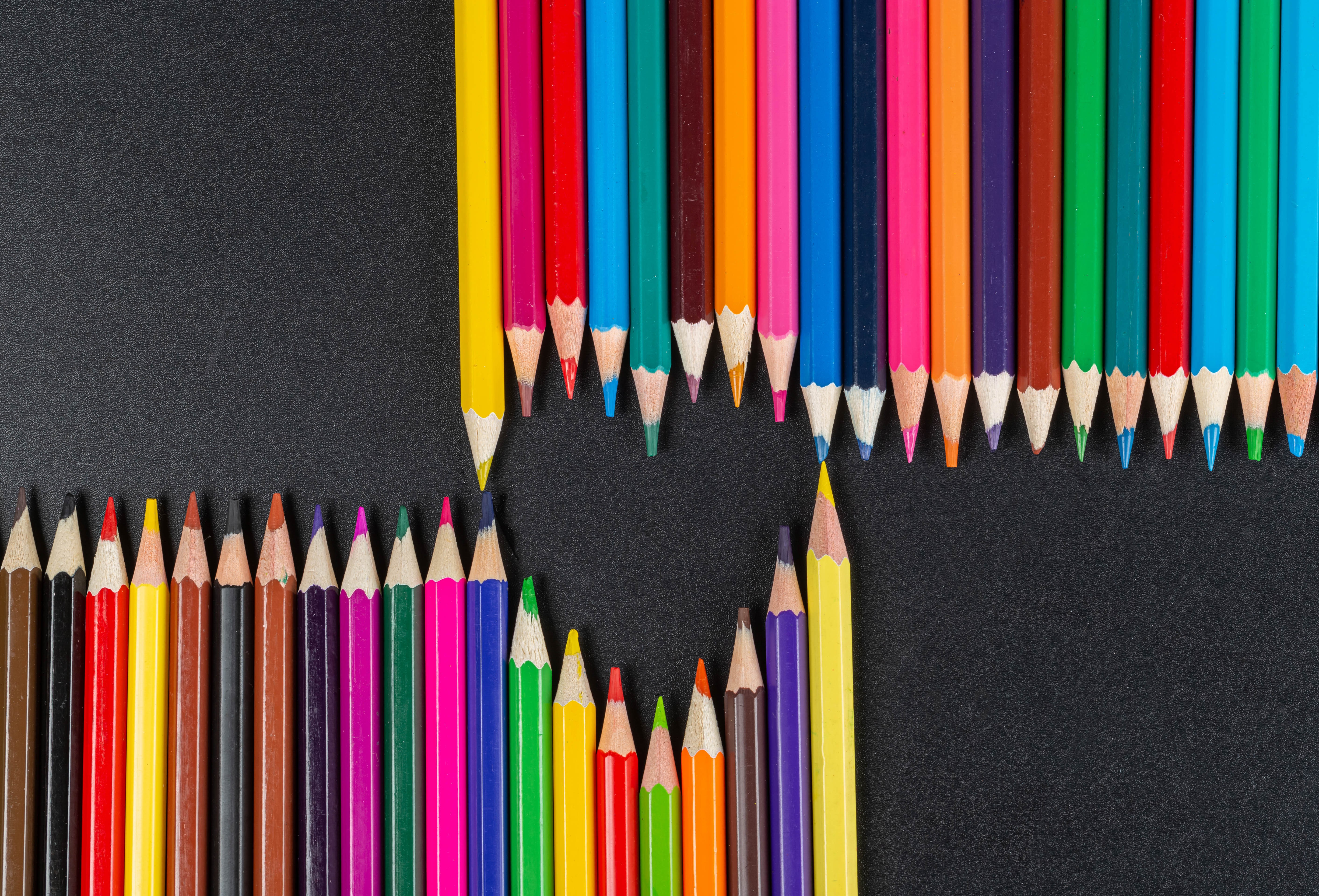 Heart shape made of multicolor pencils on gray background HD Wallpaper