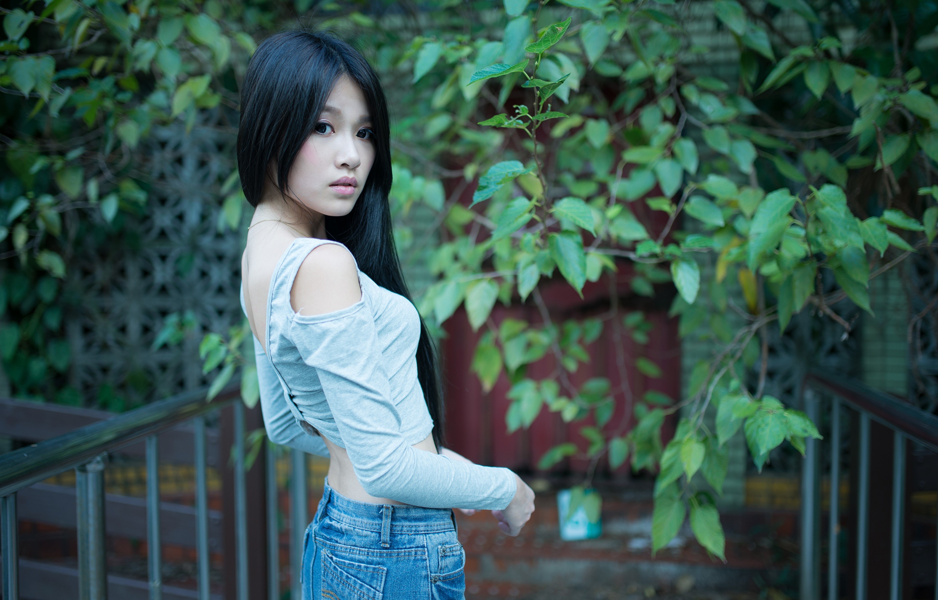 Asian girl with long dark hair in a grey top and jeans HD Wallpaper