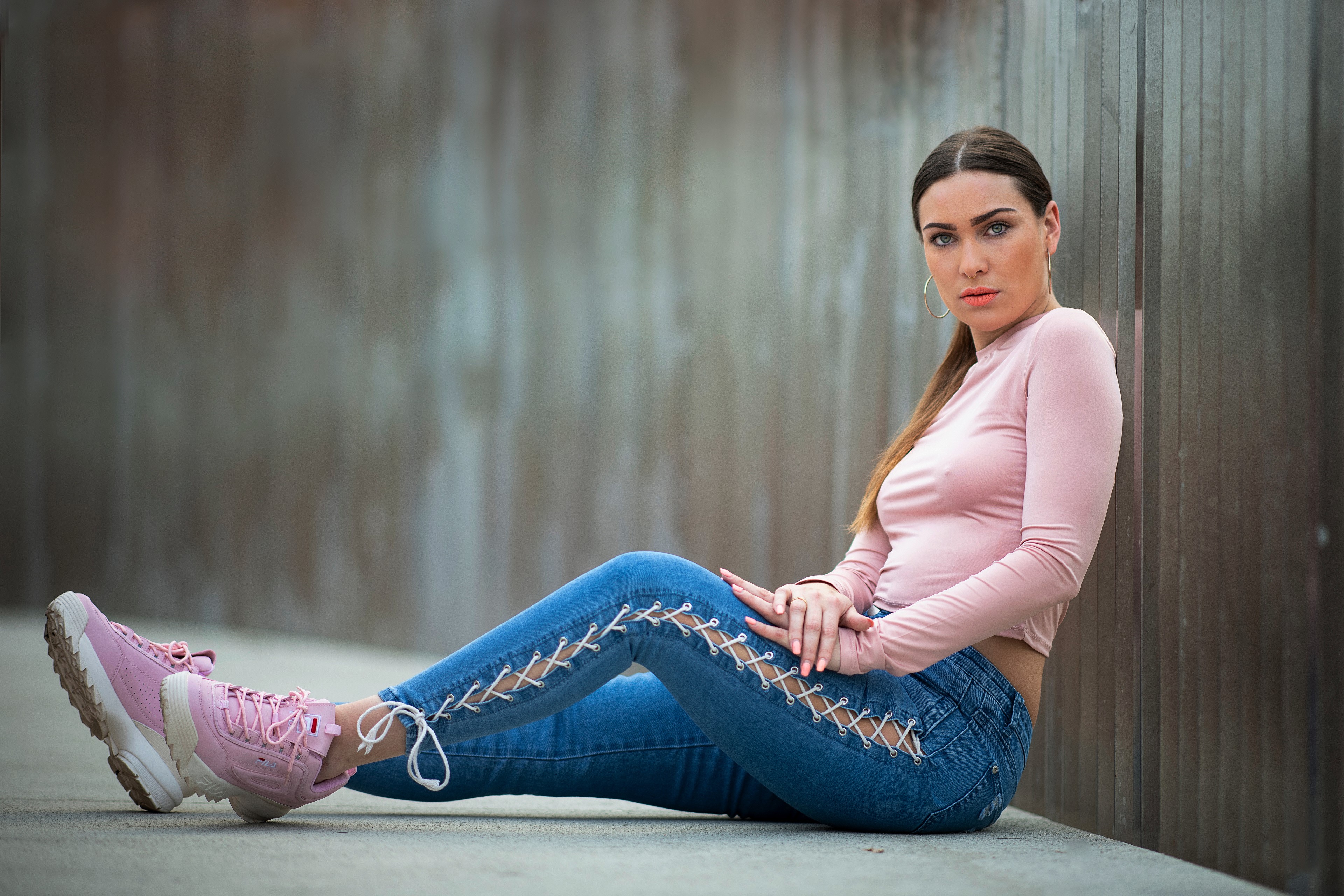 Melina sitting in jeans and athletic shoes HD Wallpaper