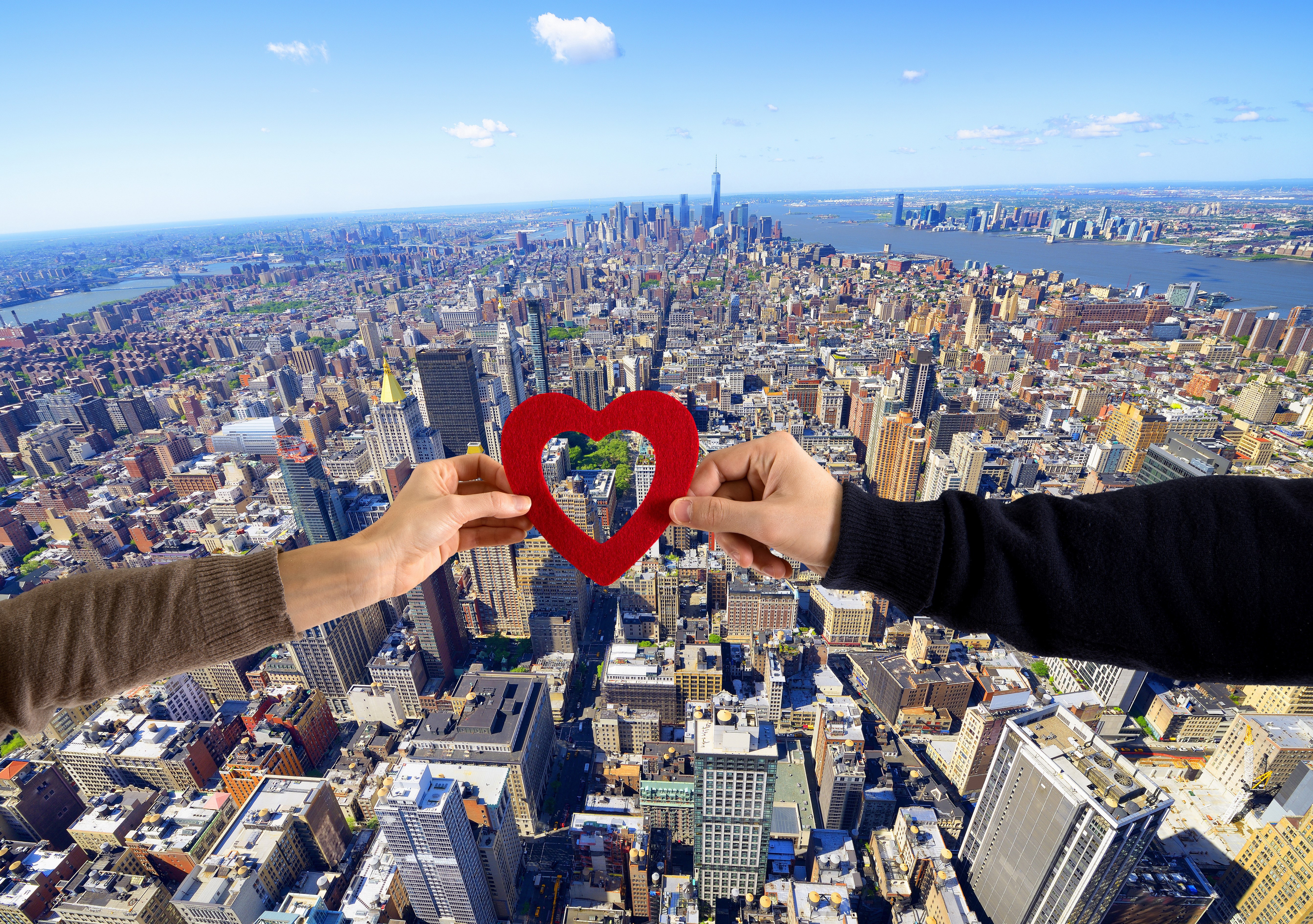 Hands holding a red heart over New York City HD Wallpaper