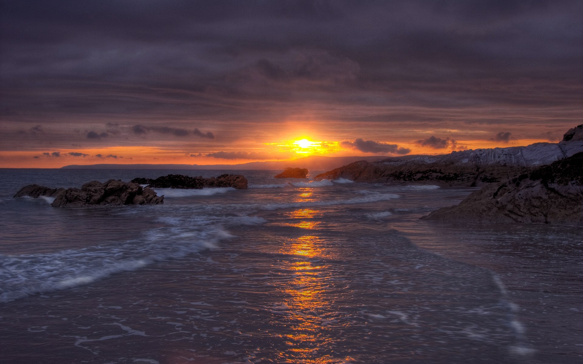 Sunset over rocky beach with ocean waves HD Wallpaper