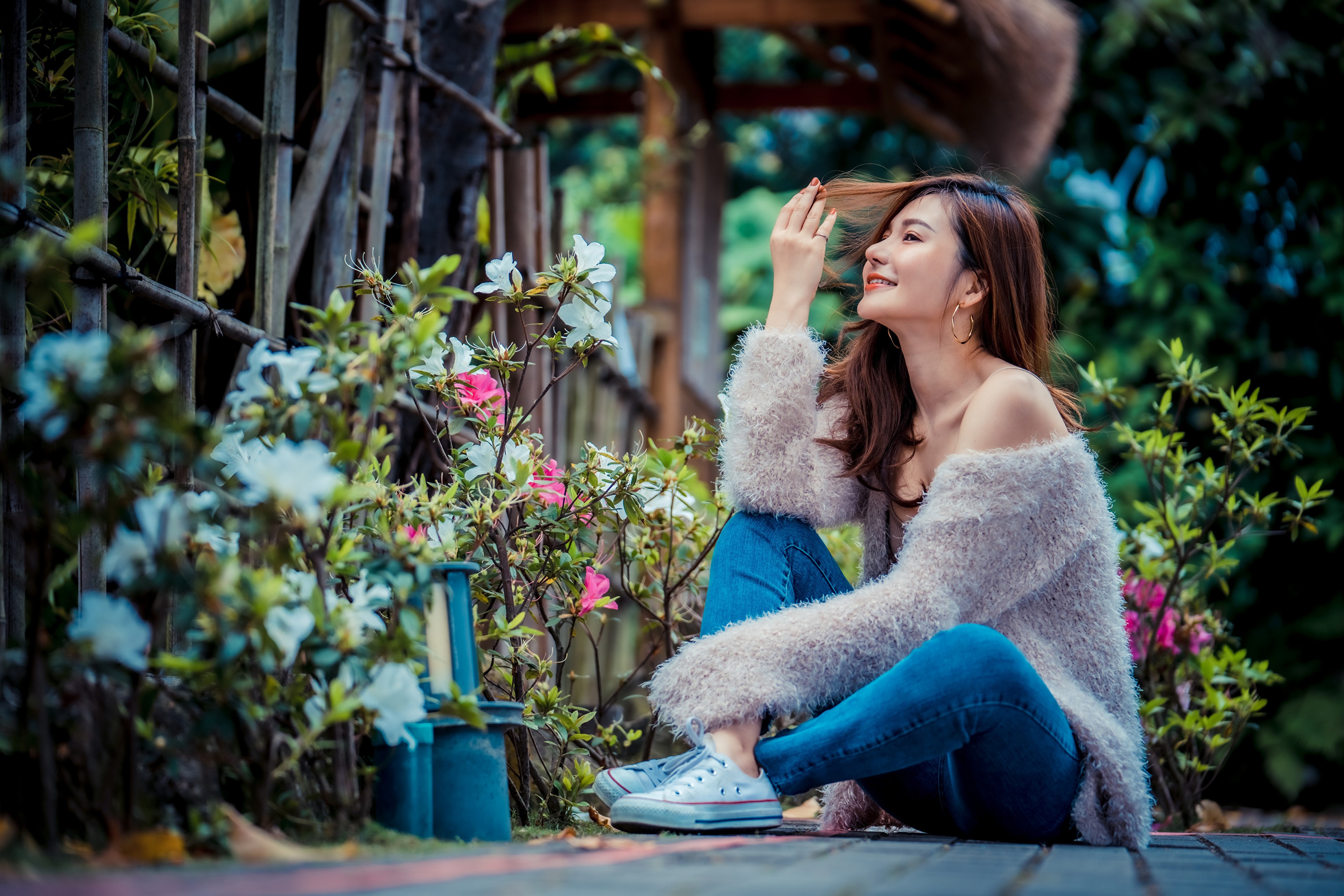 Asian woman with brown hair in jeans sitting HD Wallpaper