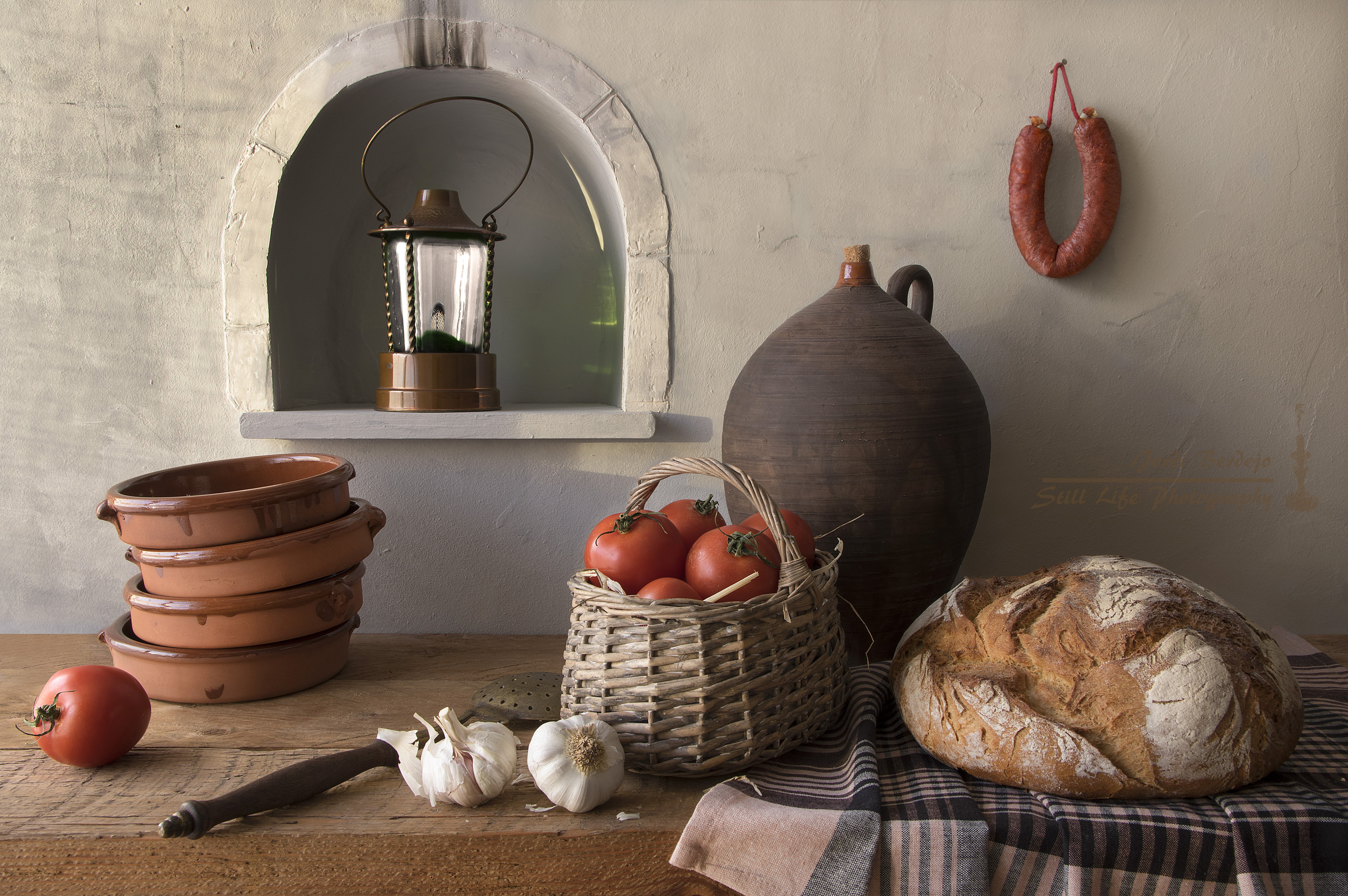 Still life with bread, tomatoes, garlic, sausage, lantern, and pottery HD Wallpaper