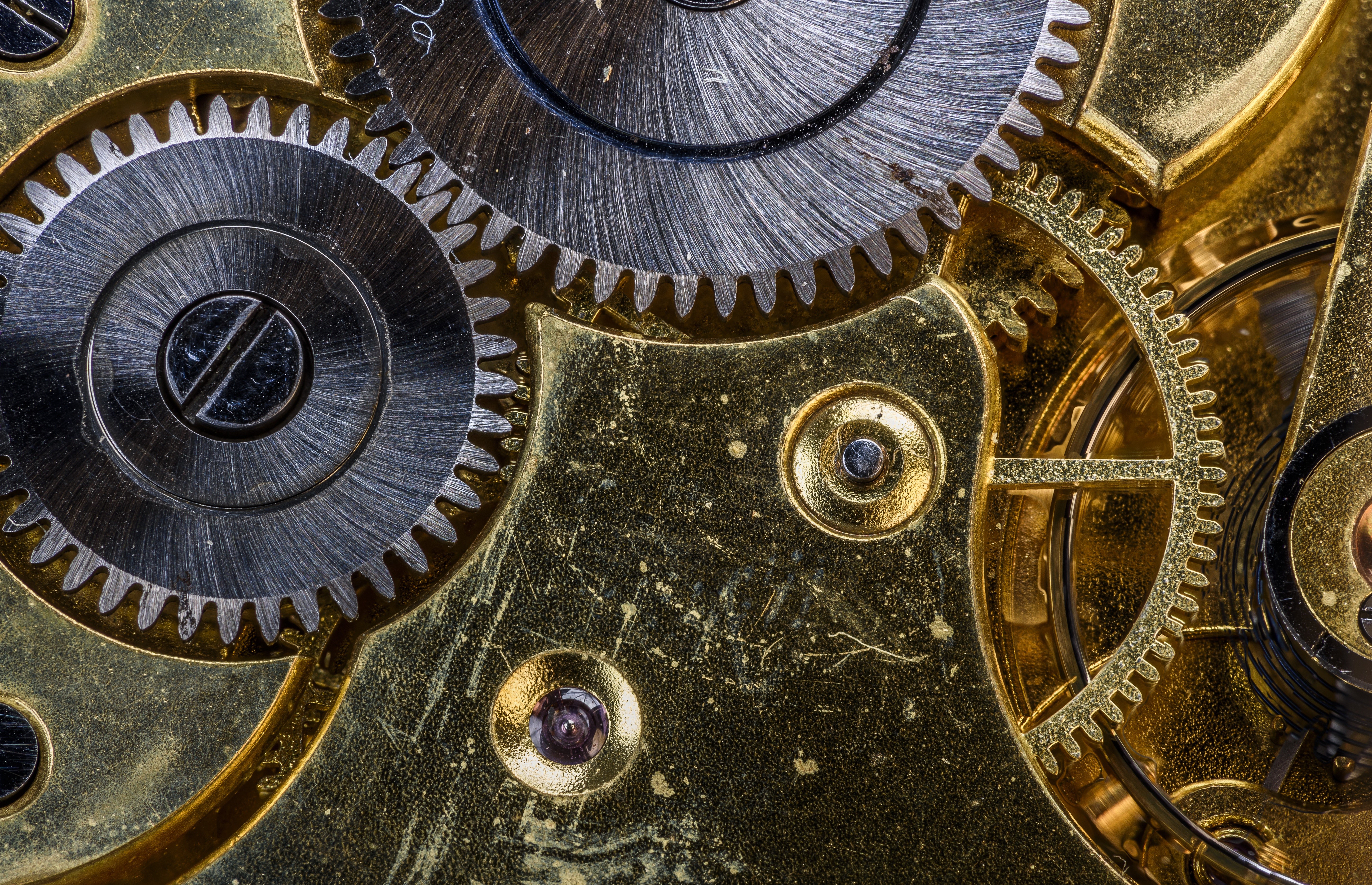 Closeup of a mechanical watch mechanism with gears HD Wallpaper