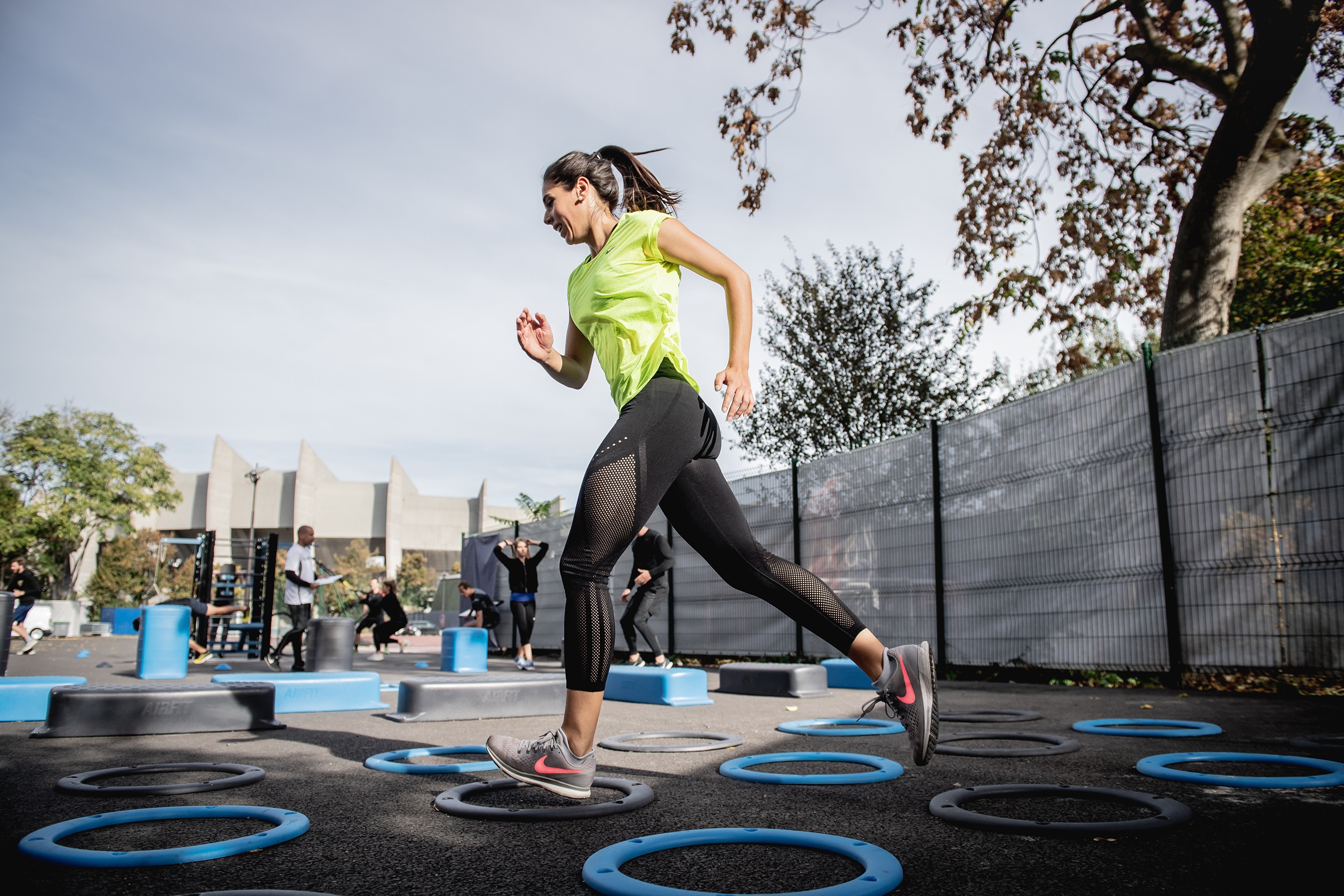 Woman running on agility circles during outdoor fitness workout HD Wallpaper