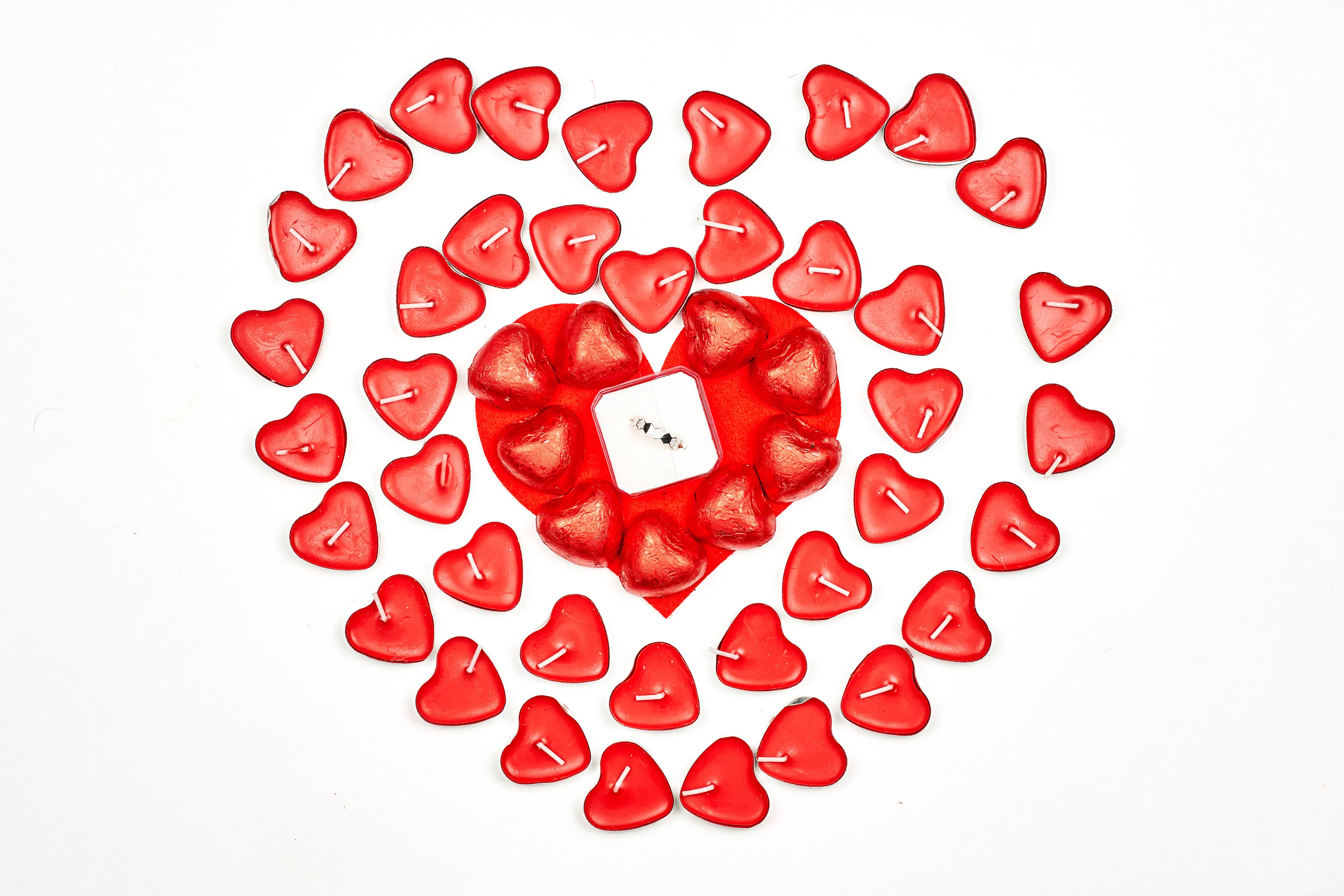 Heart shaped candles and ring on white background HD Wallpaper