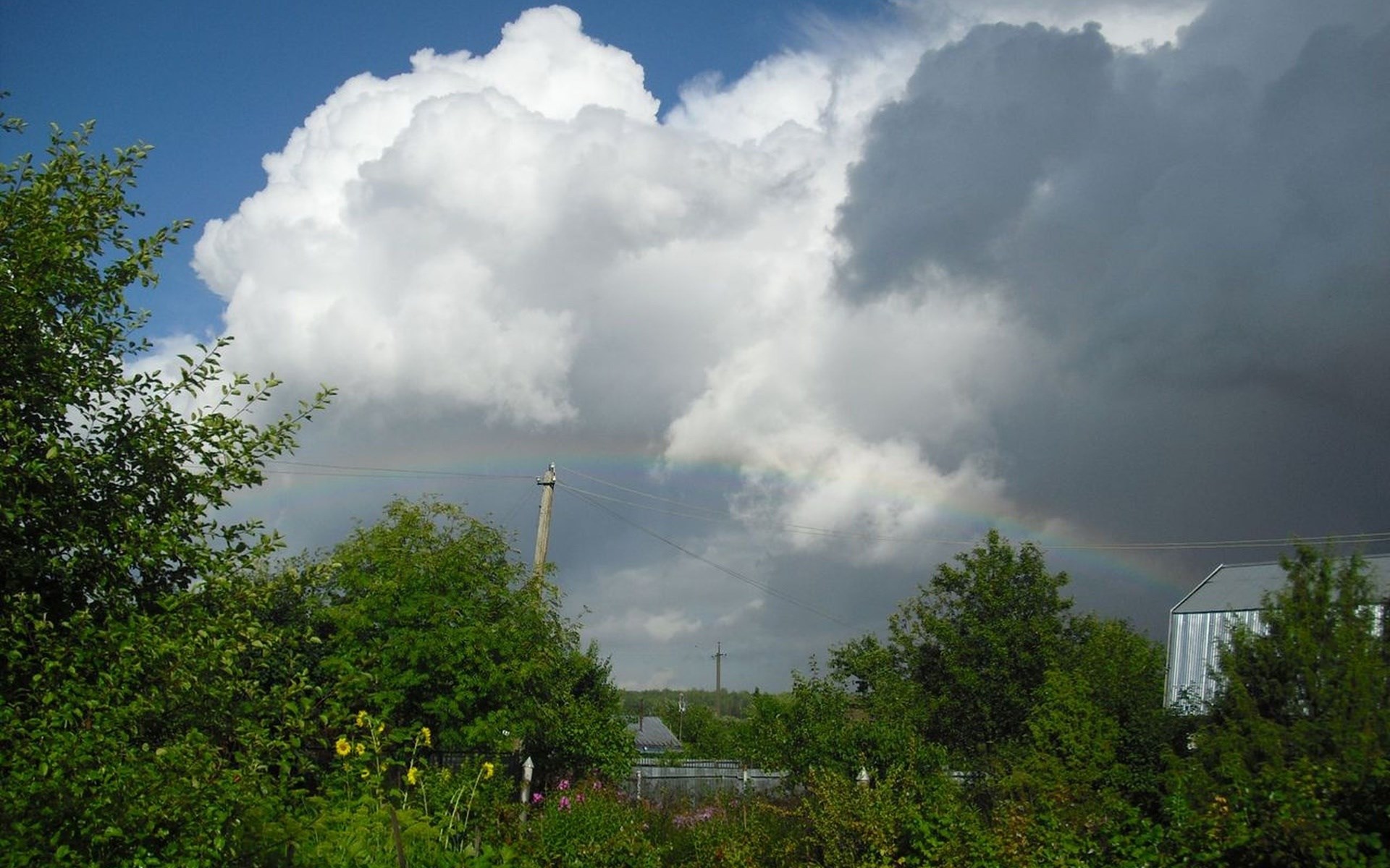 Rainbow over a rural landscape with trees and clouds HD Wallpaper