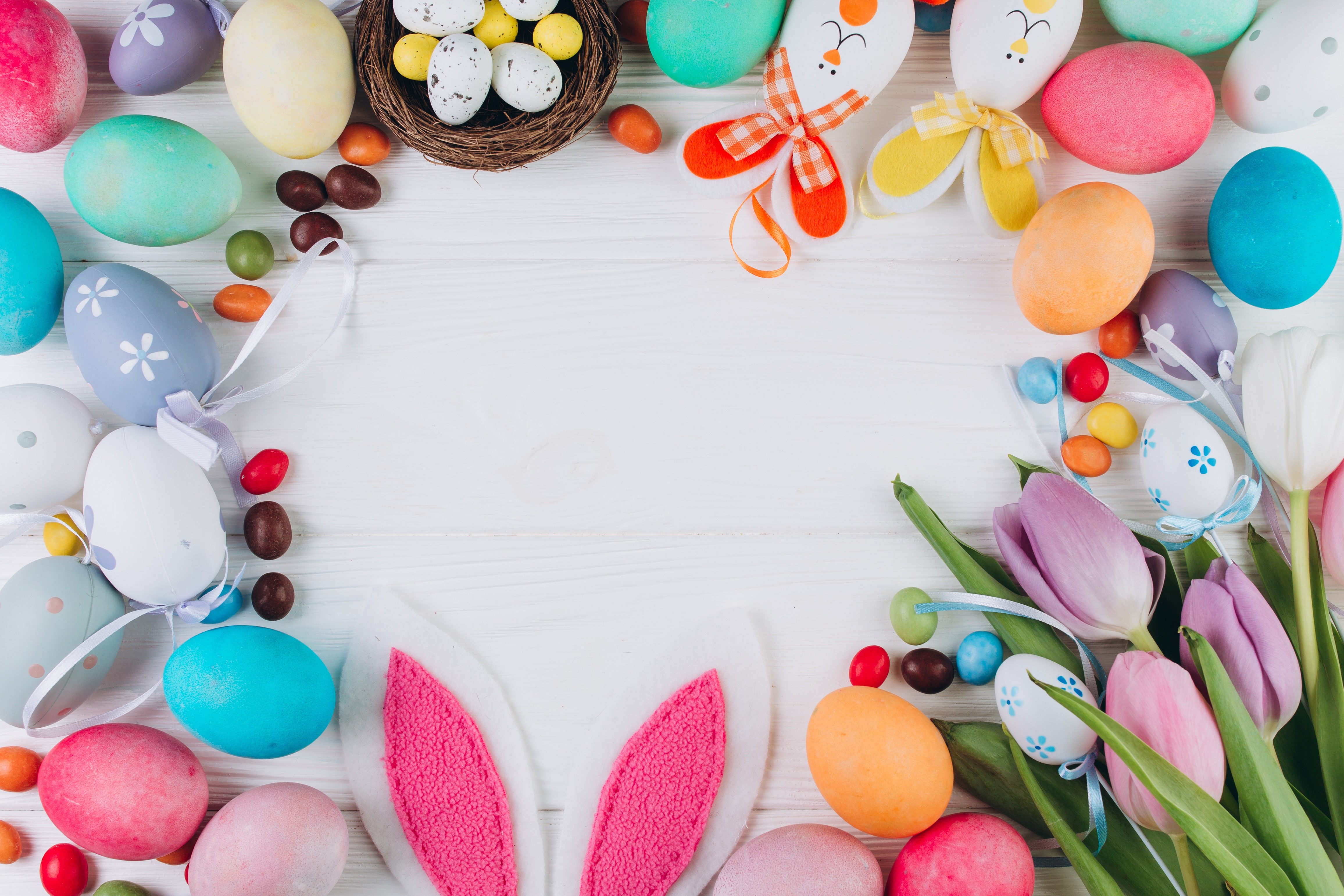 Easter eggs and tulips on a white wooden table HD Wallpaper