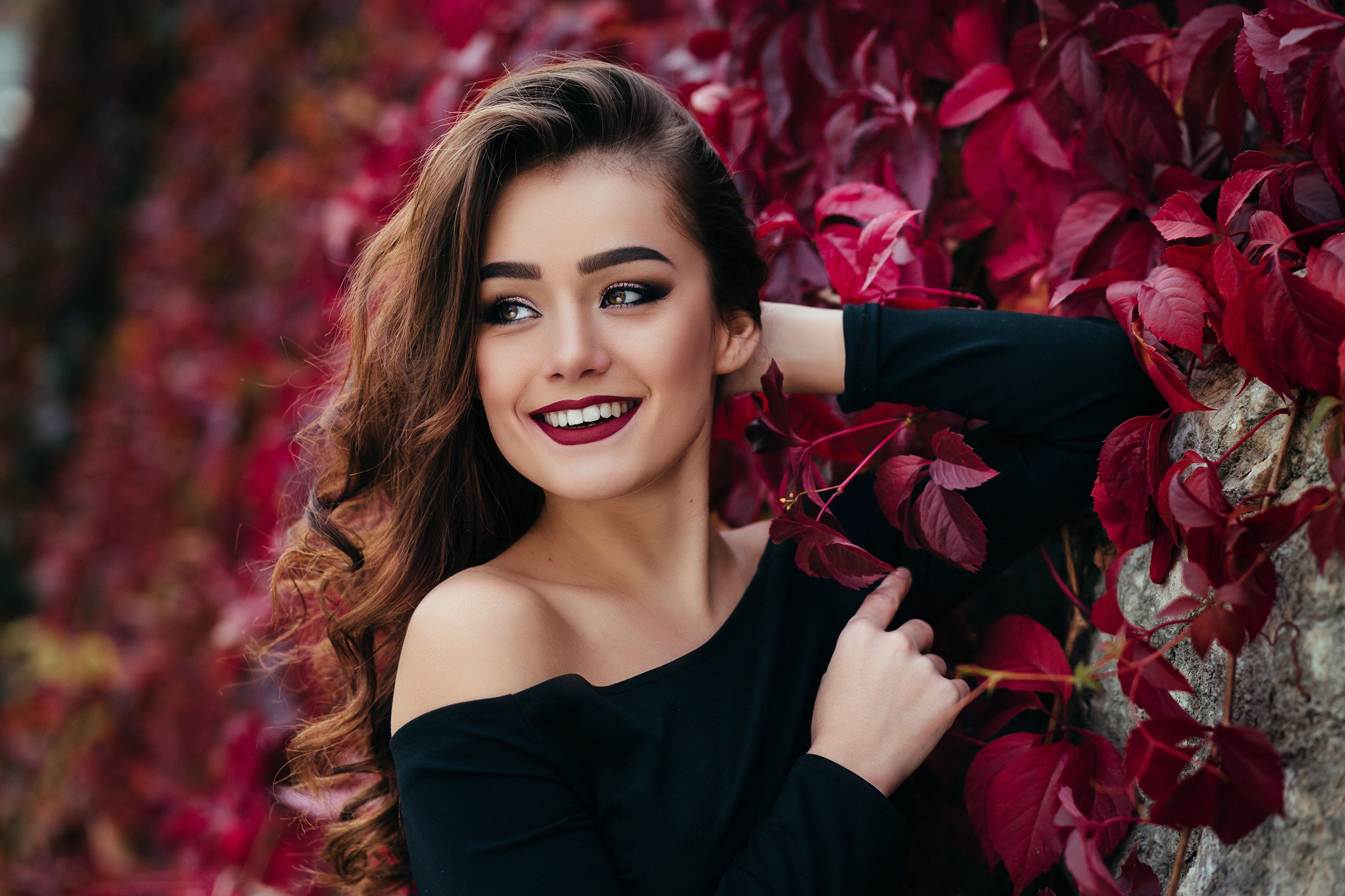 Woman with brown hair and makeup smiling HD Wallpaper