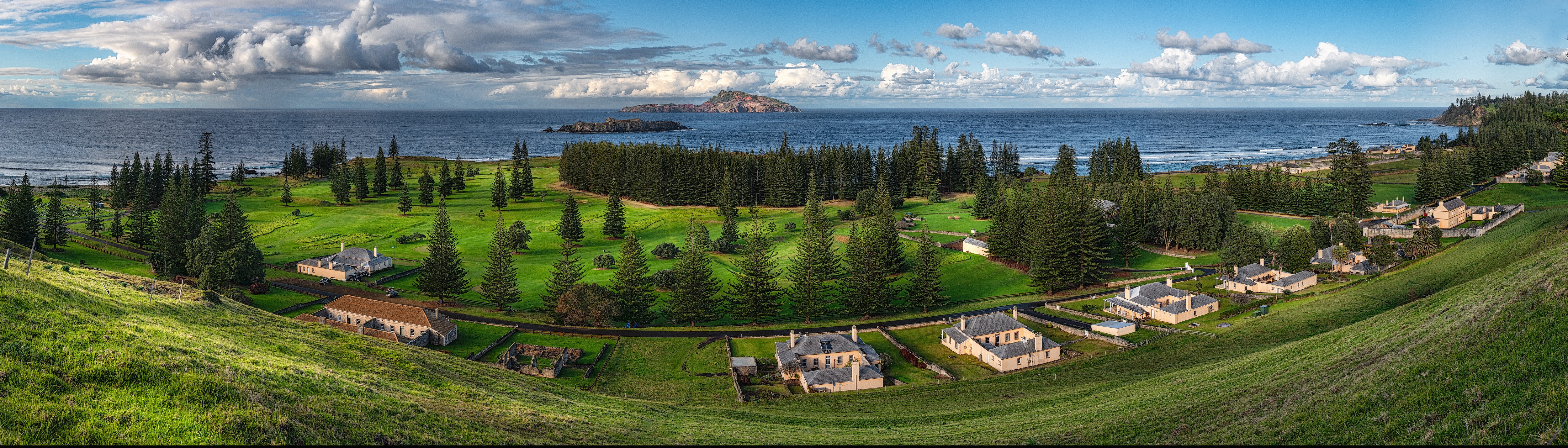 Norfolk Island Coast Panorama with Houses and Clouds HD Wallpaper