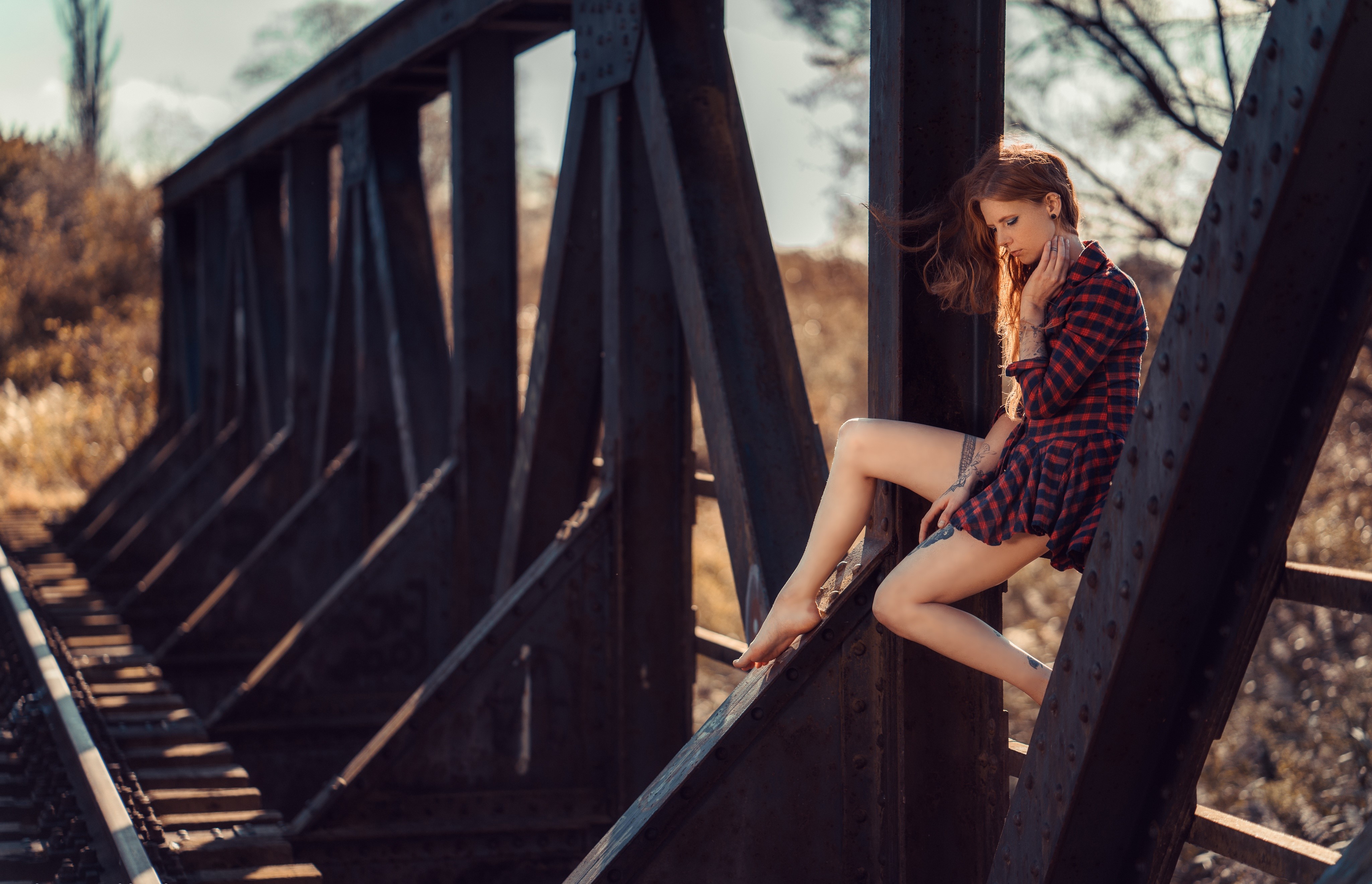Woman with red hair sitting on a bridge HD Wallpaper