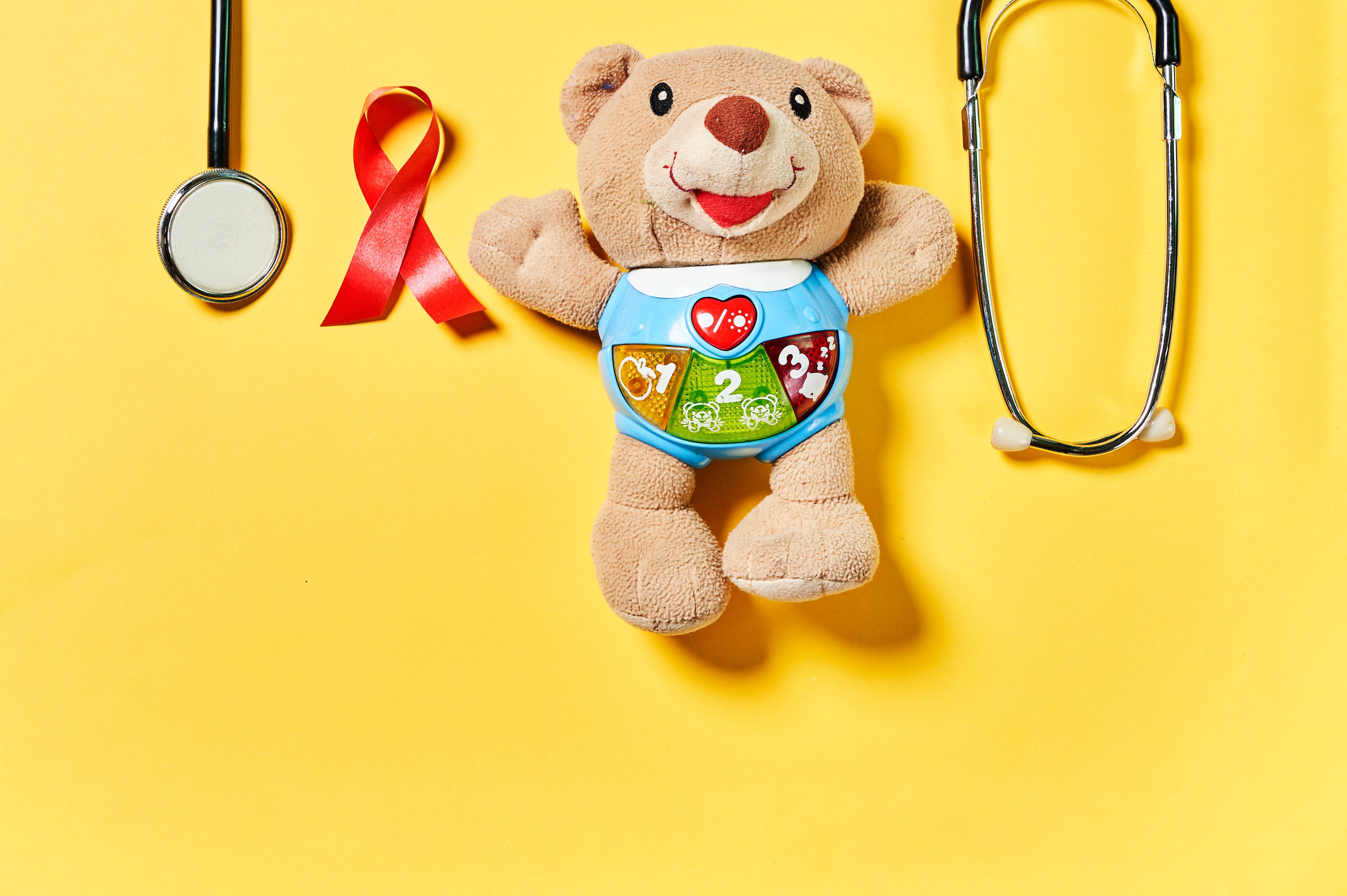 Teddy bear with stethoscope and red ribbon HD Wallpaper