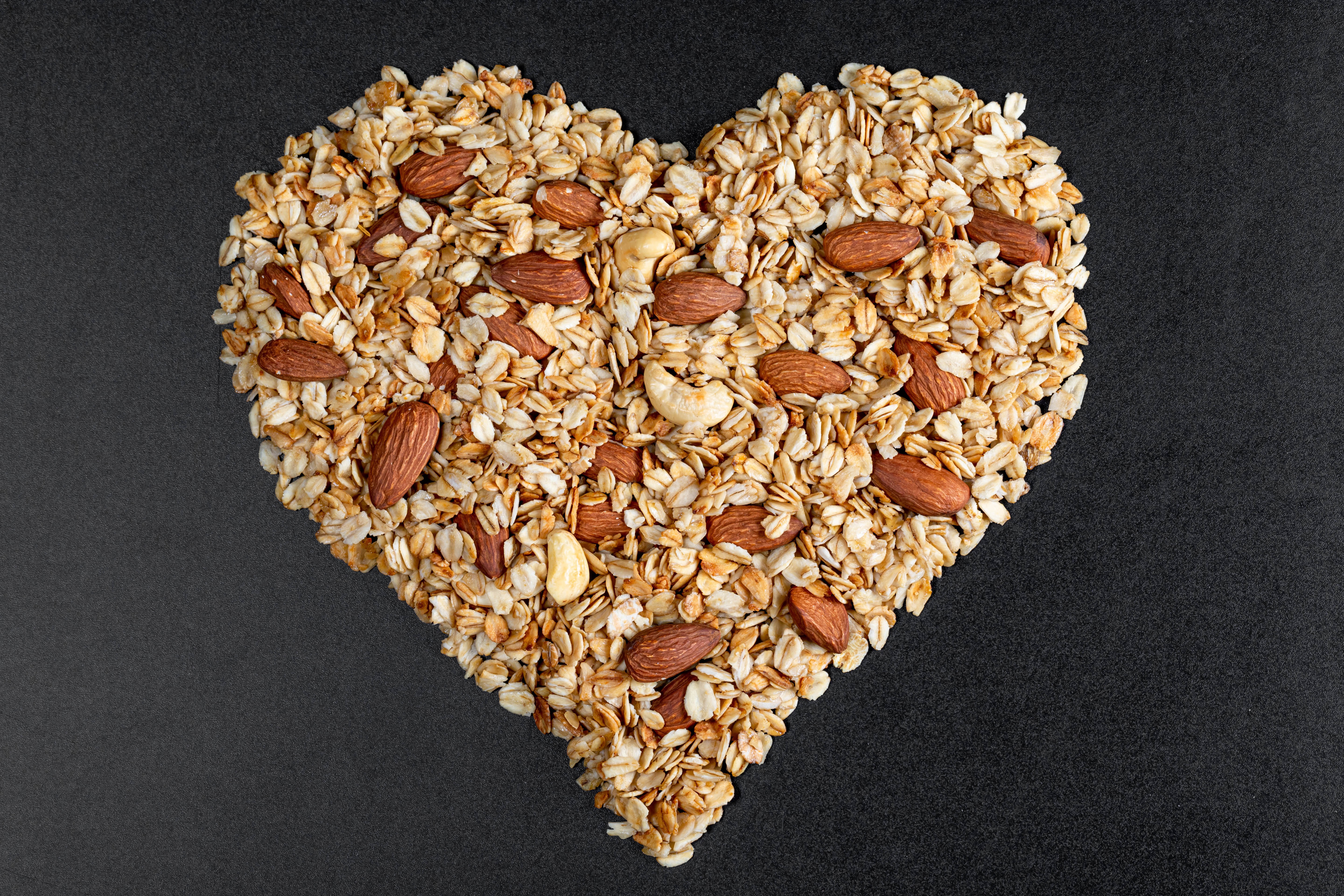 Heart shape granola with almonds and cashews HD Wallpaper