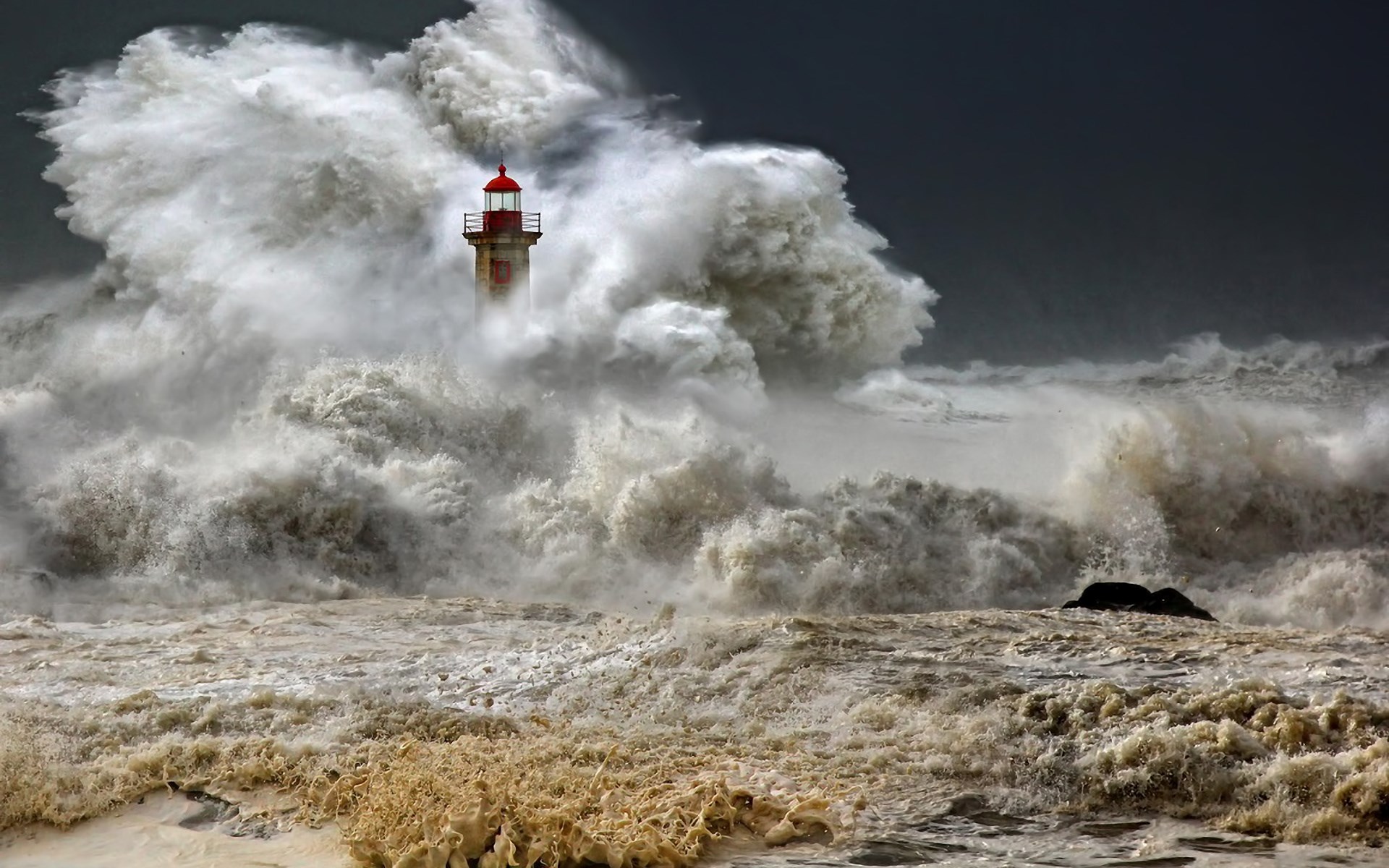 Lighthouse amidst a powerful storm and massive waves HD Wallpaper