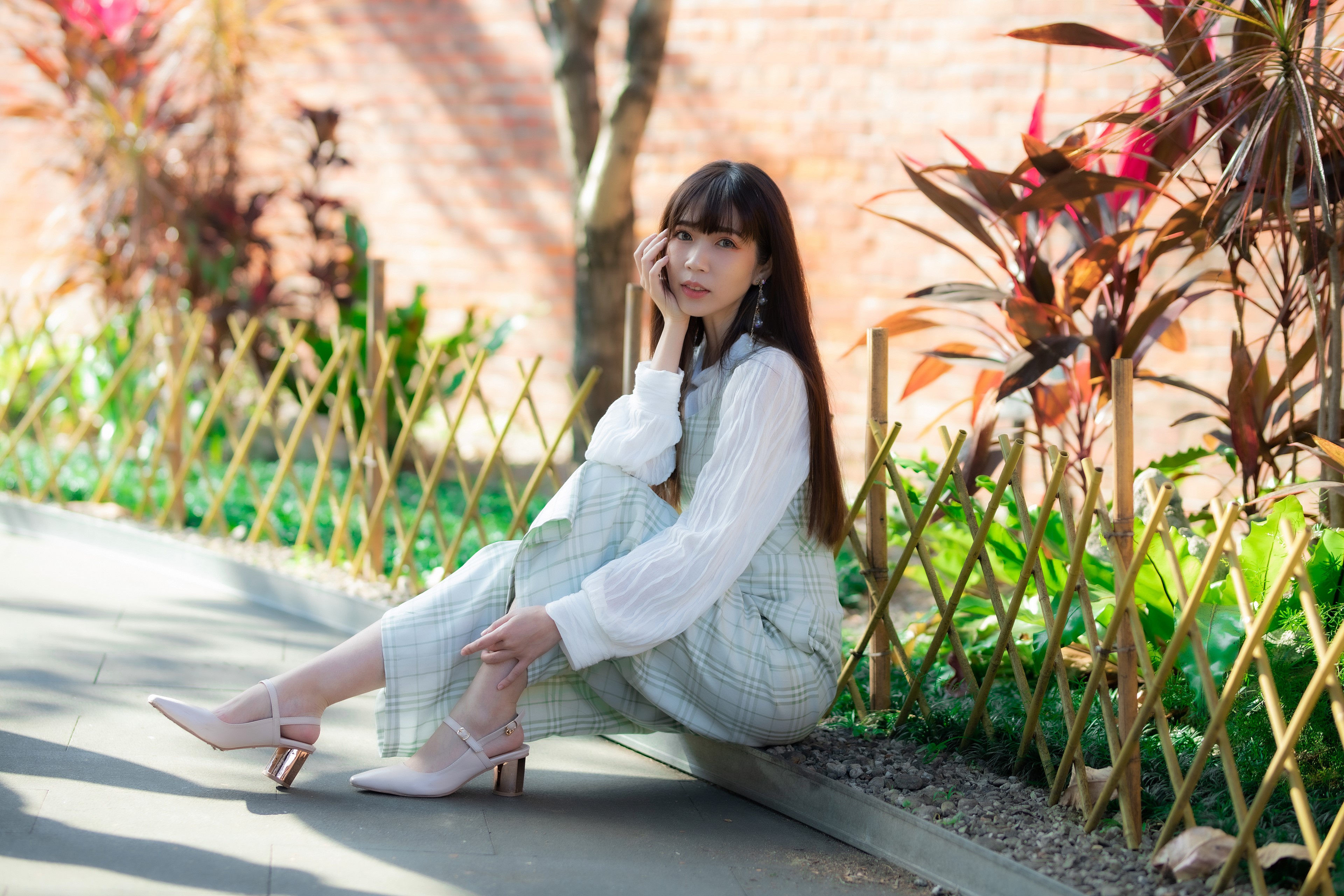 4K Asian Woman Sitting with Gentle Glance HD Wallpaper