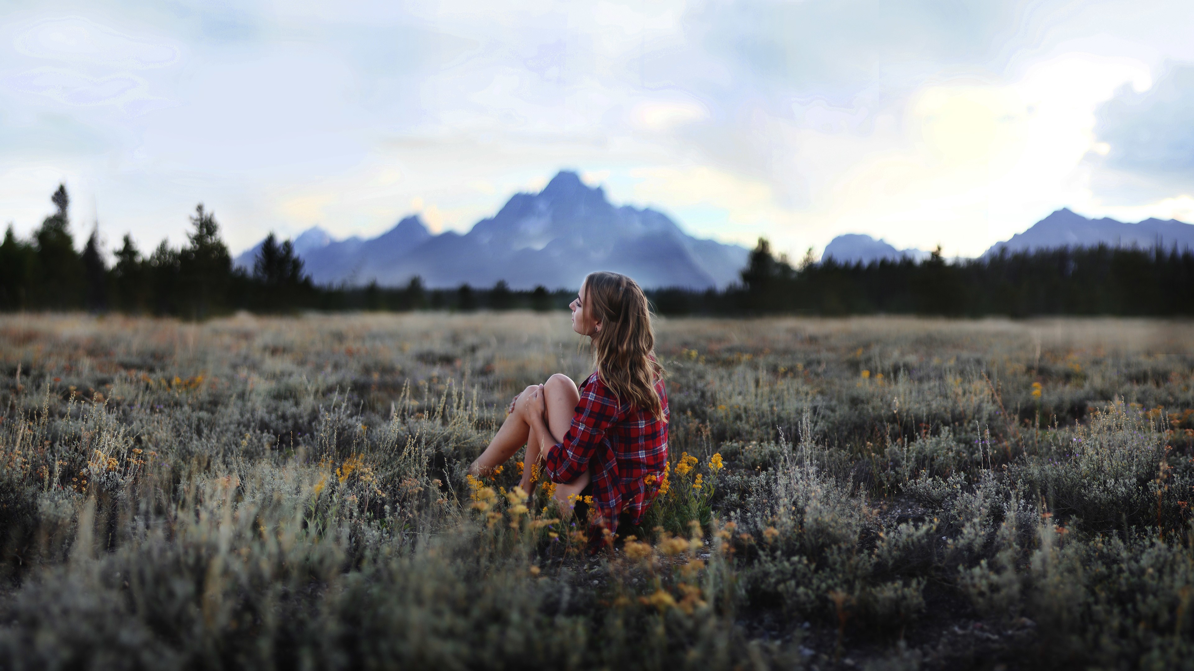 Woman in field with mountains in background HD Wallpaper