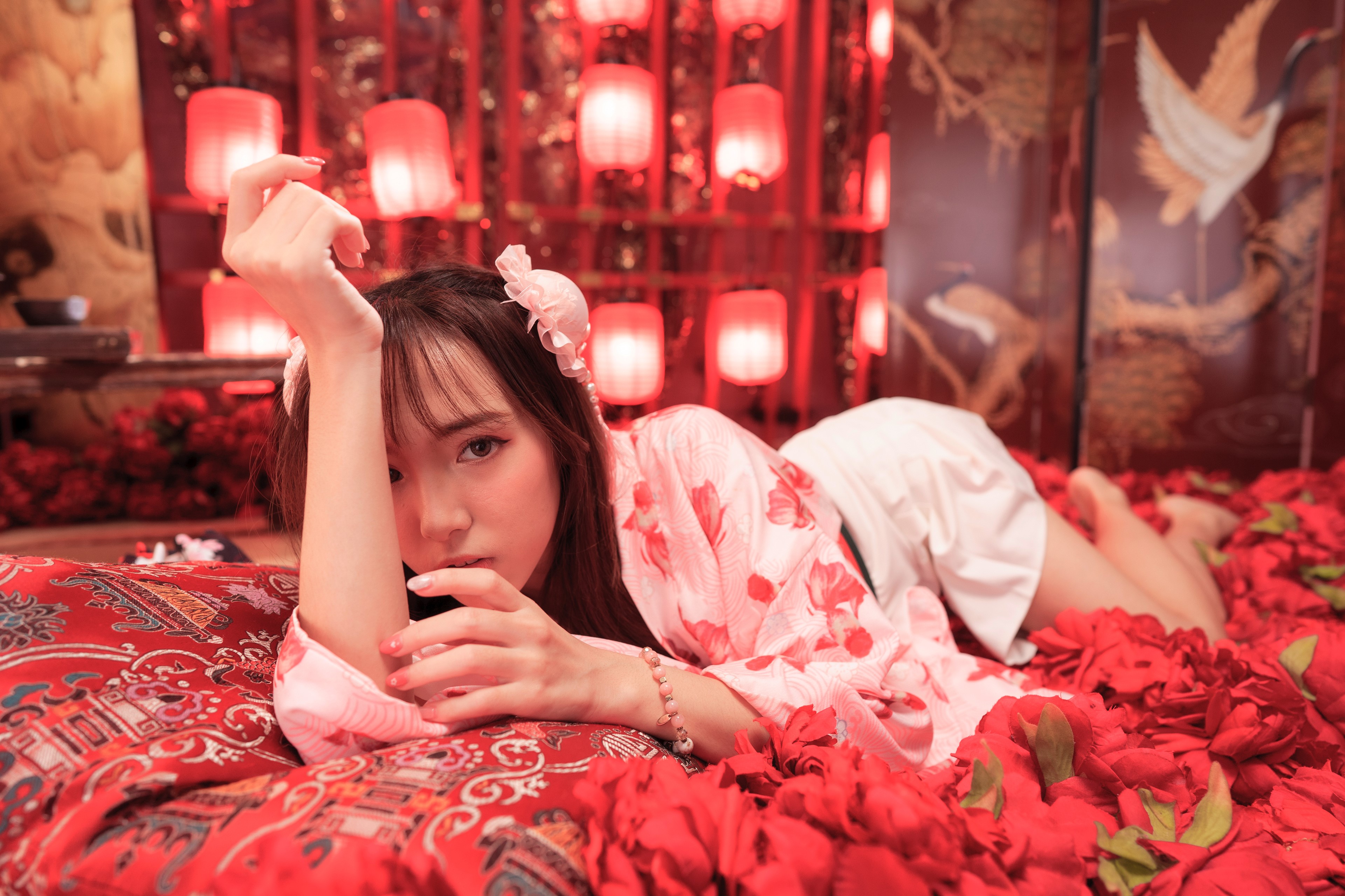 Asian woman in kimono lying down surrounded by petals HD Wallpaper