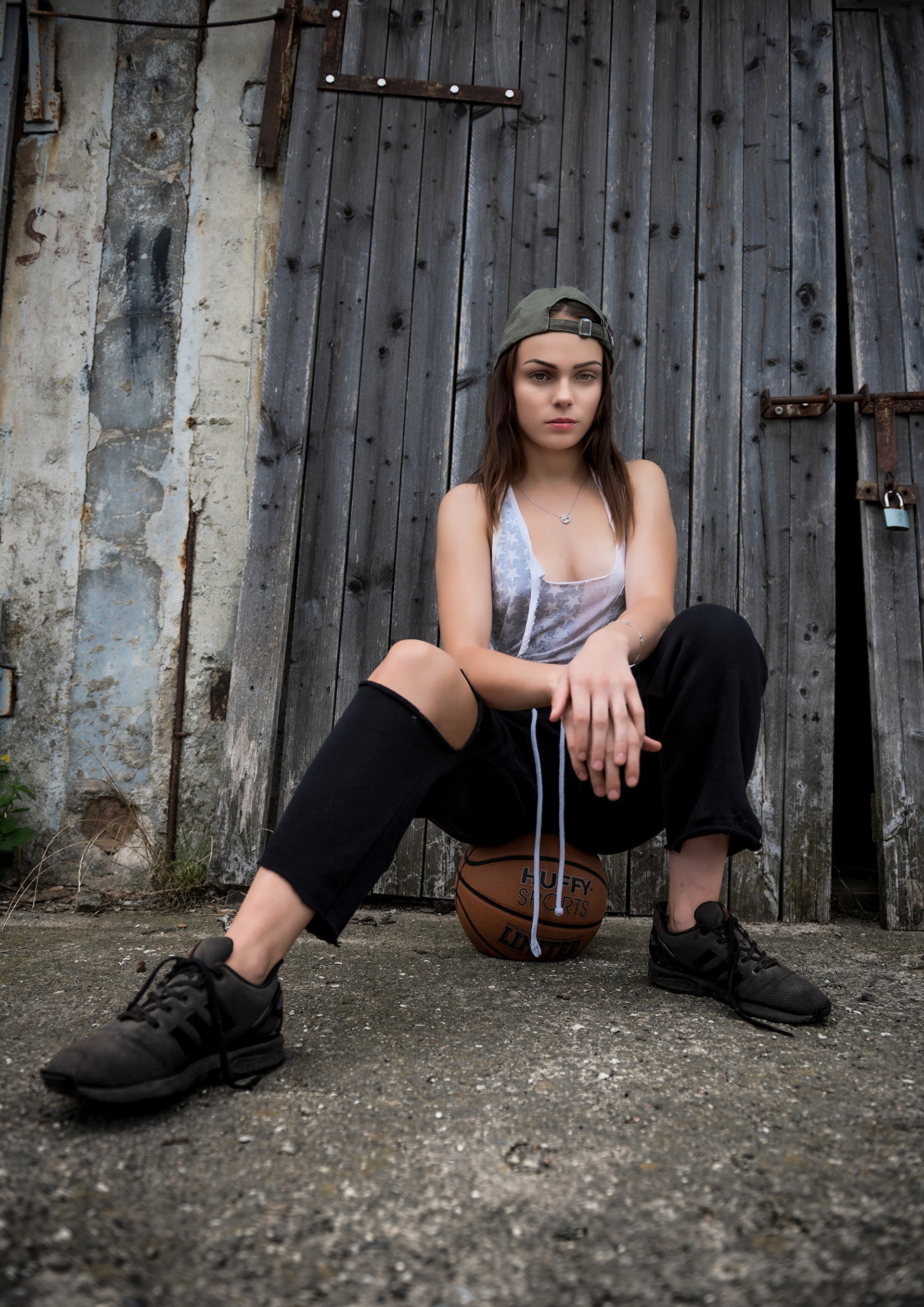 Klaudia Latto sitting on a basketball HD Phone Wallpaper