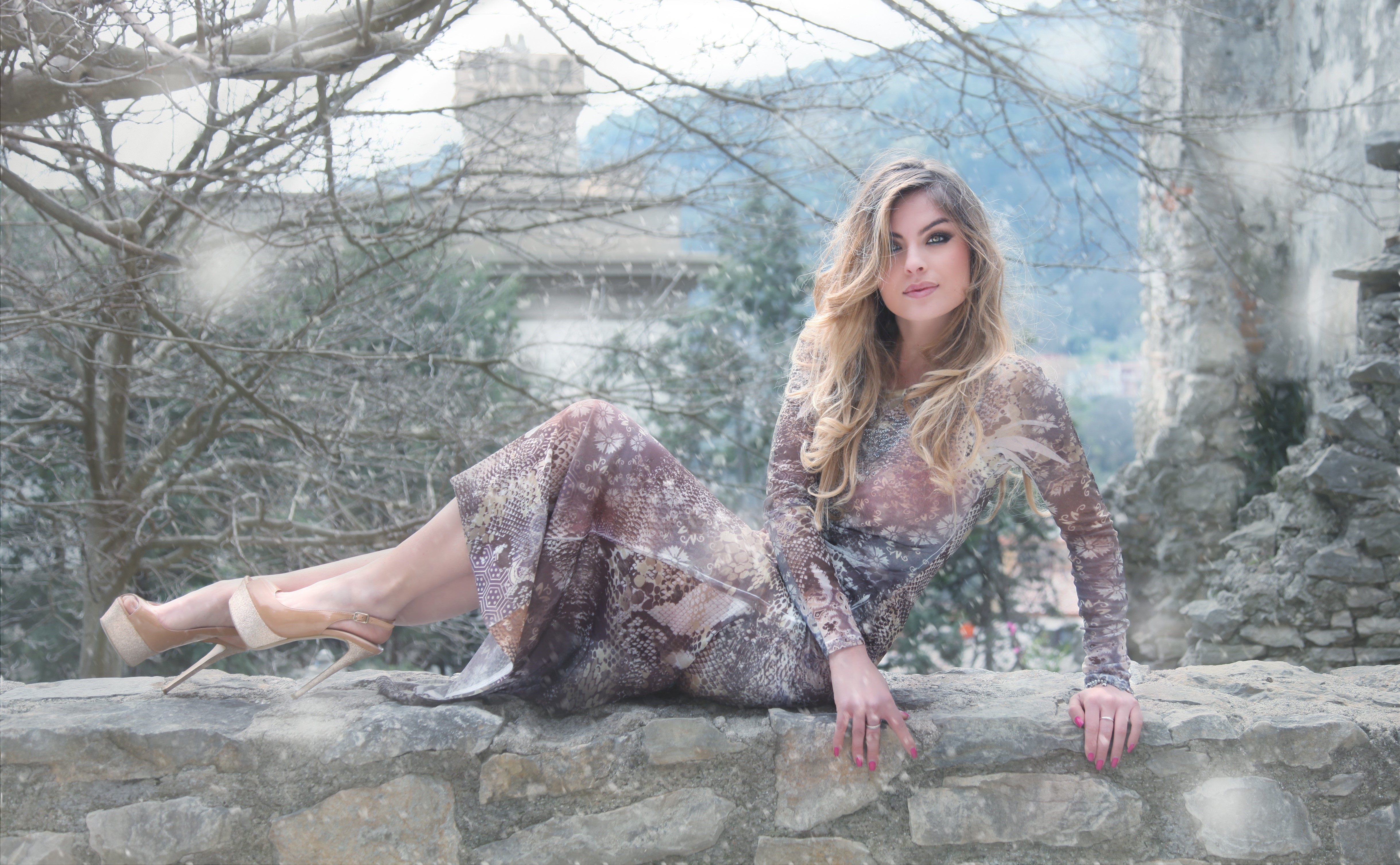 Blonde woman in a dress posing on a stone wall HD Wallpaper
