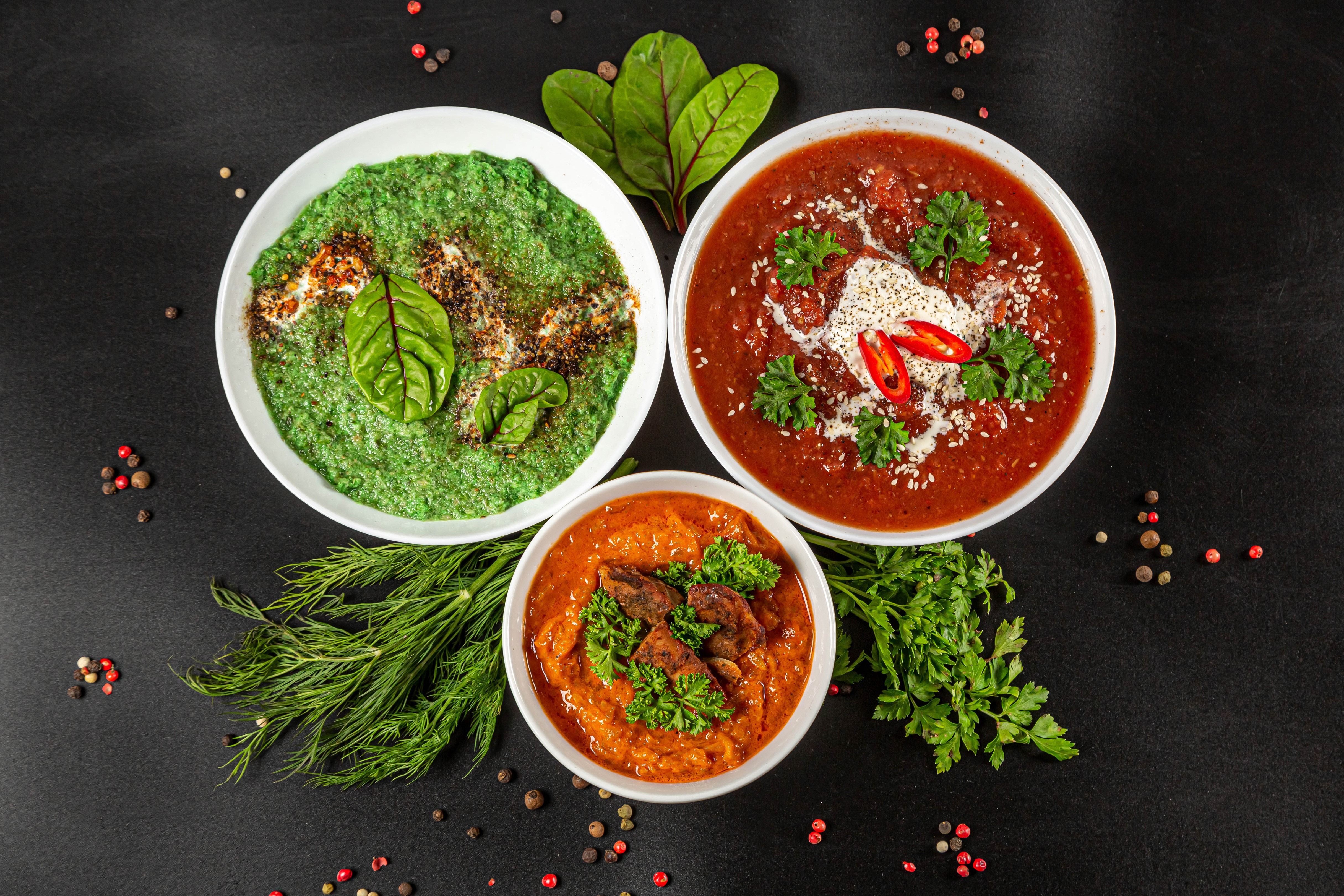 Three bowls of soup with dill and peppercorns HD Wallpaper