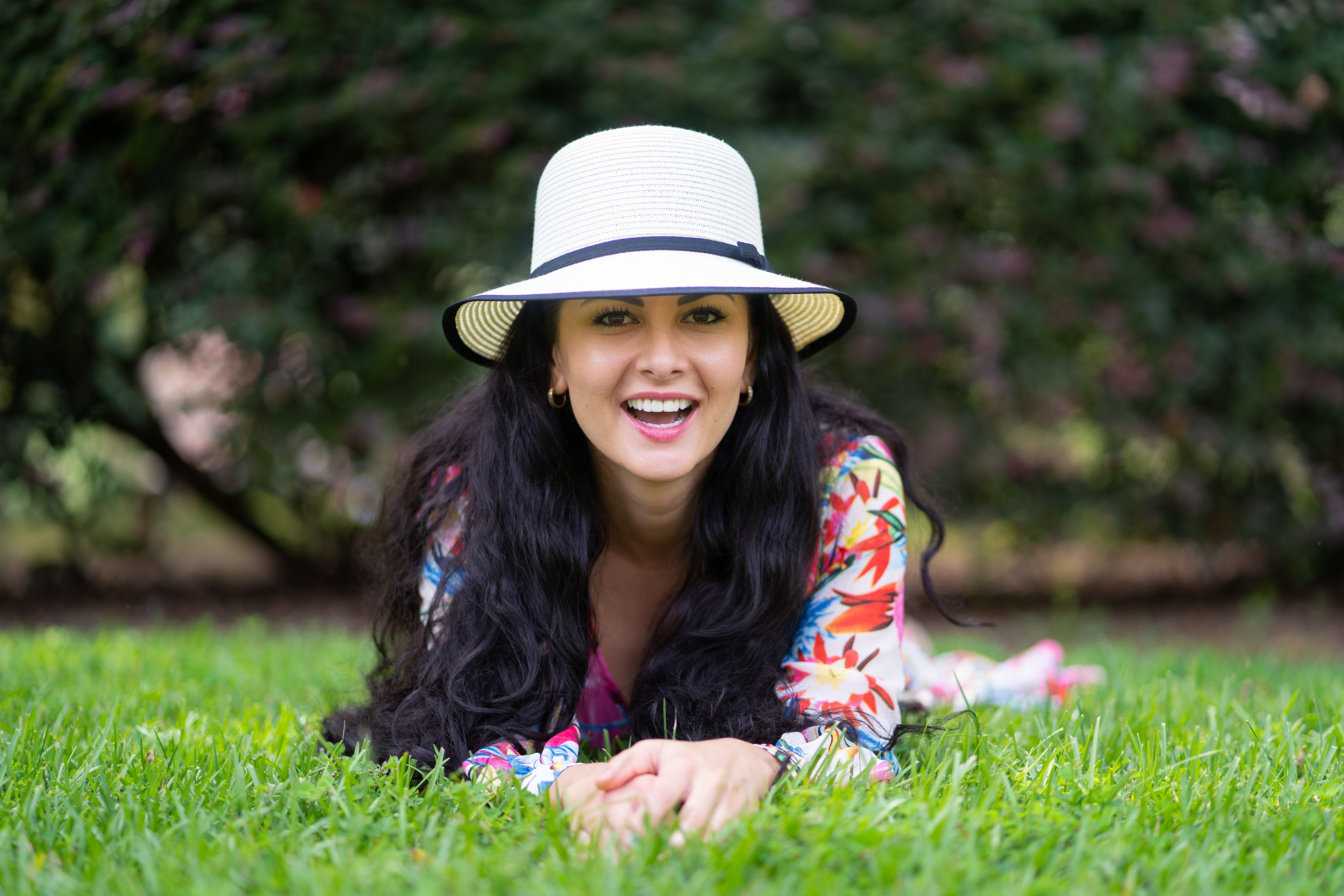 Victoria Bell lying on grass wearing a hat HD Wallpaper