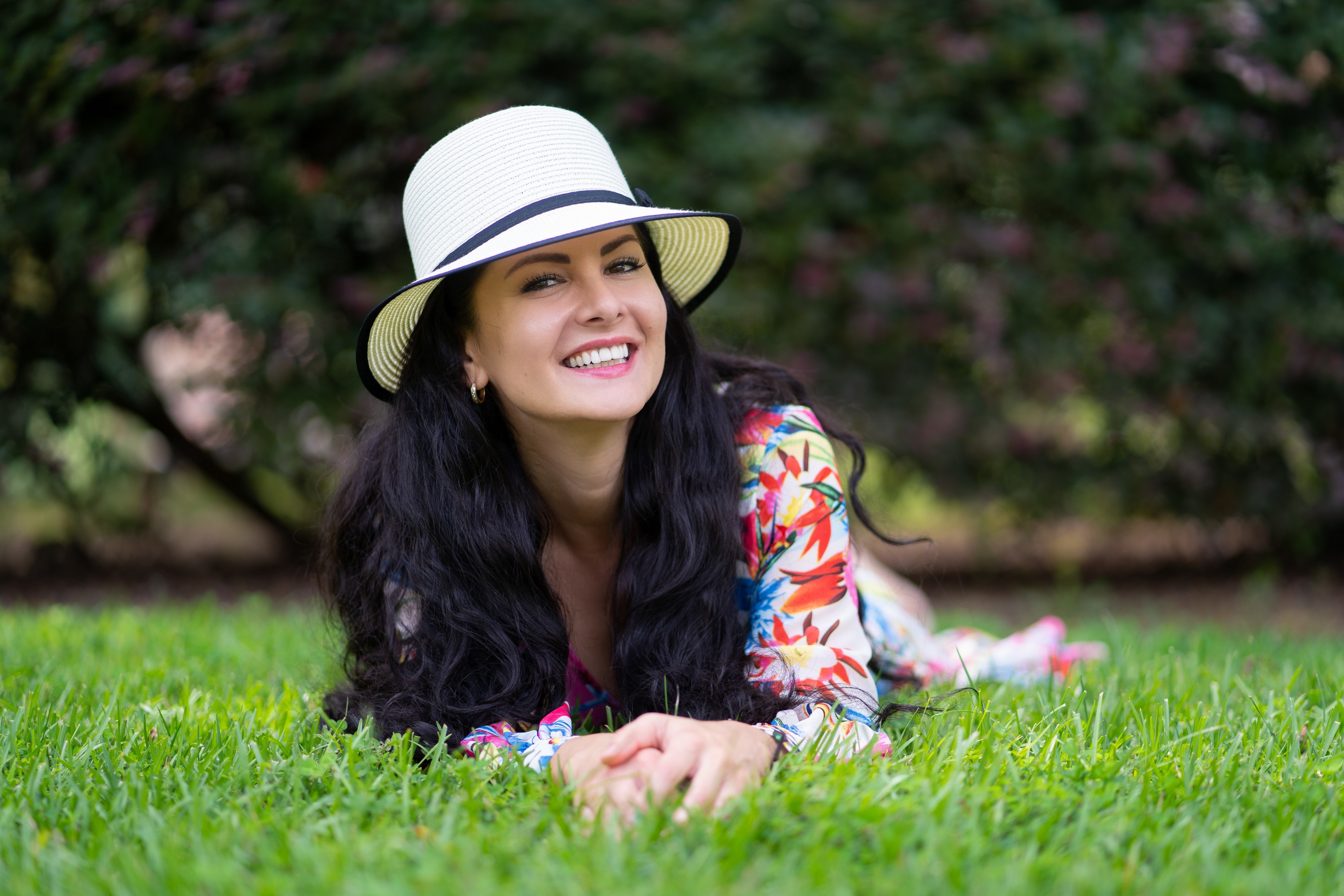 Victoria Bel lying on grass wearing a hat HD Wallpaper