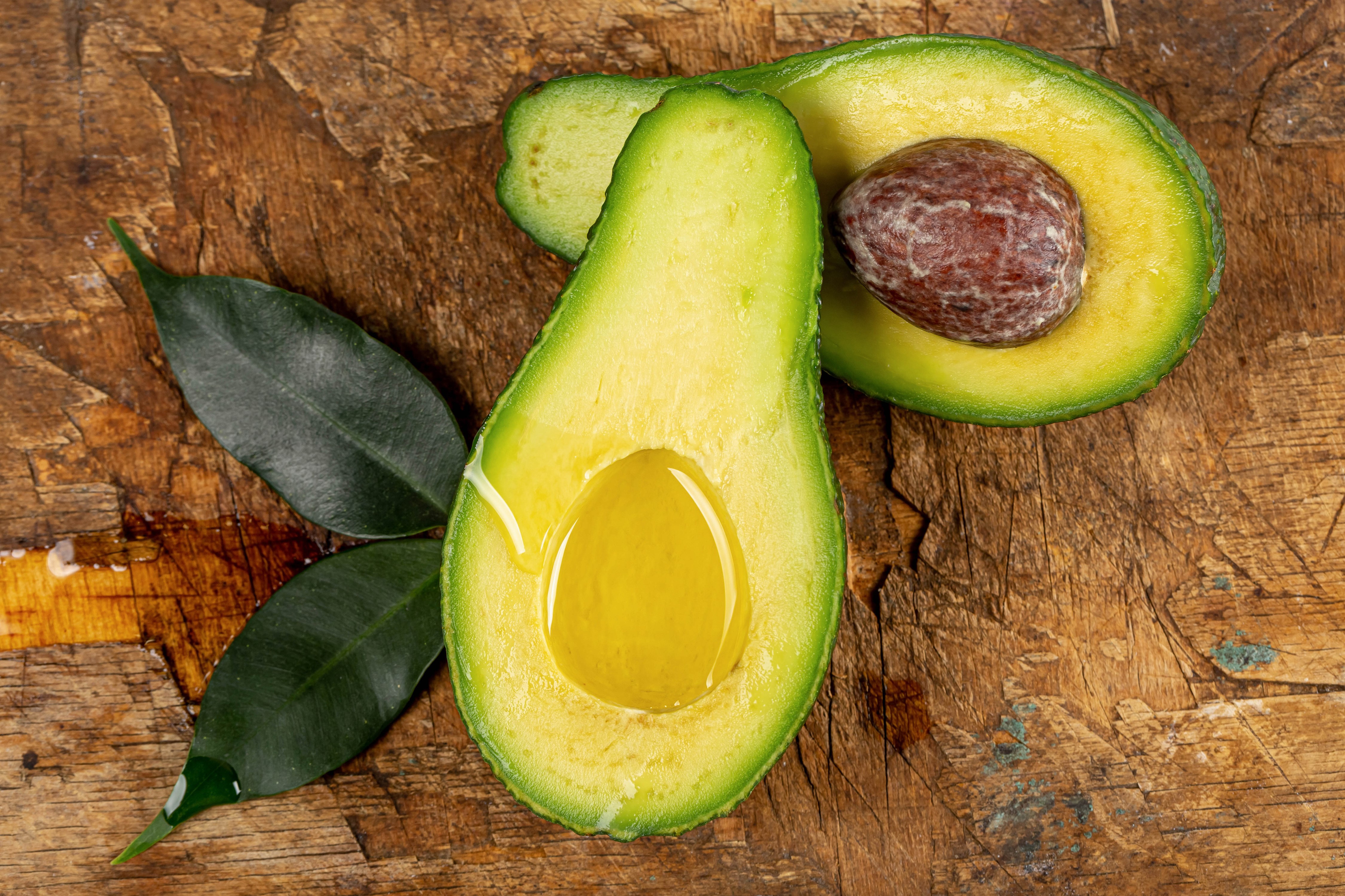 Avocado with leaves on wooden background HD Wallpaper