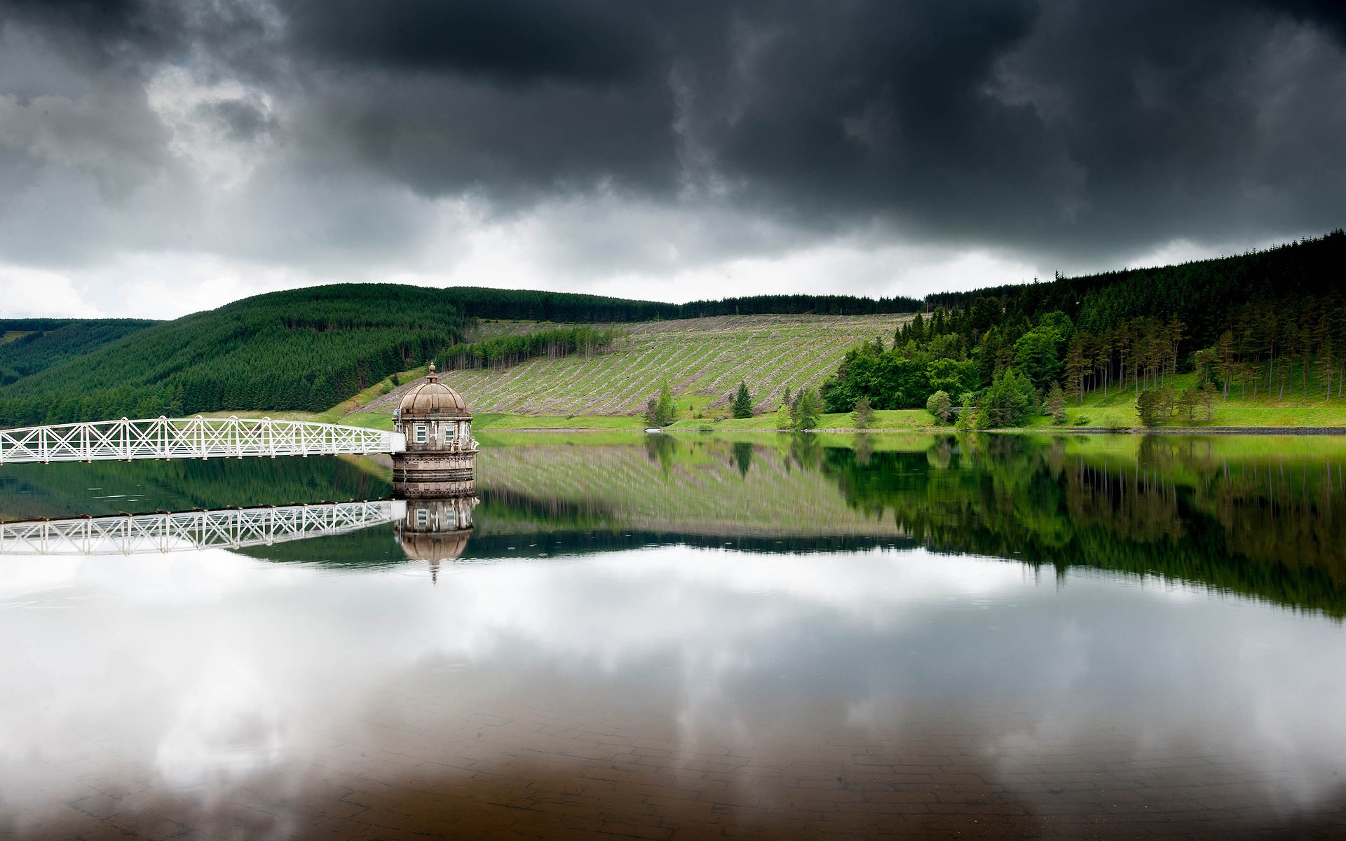 Dam with tower and bridge reflected in water HD Wallpaper