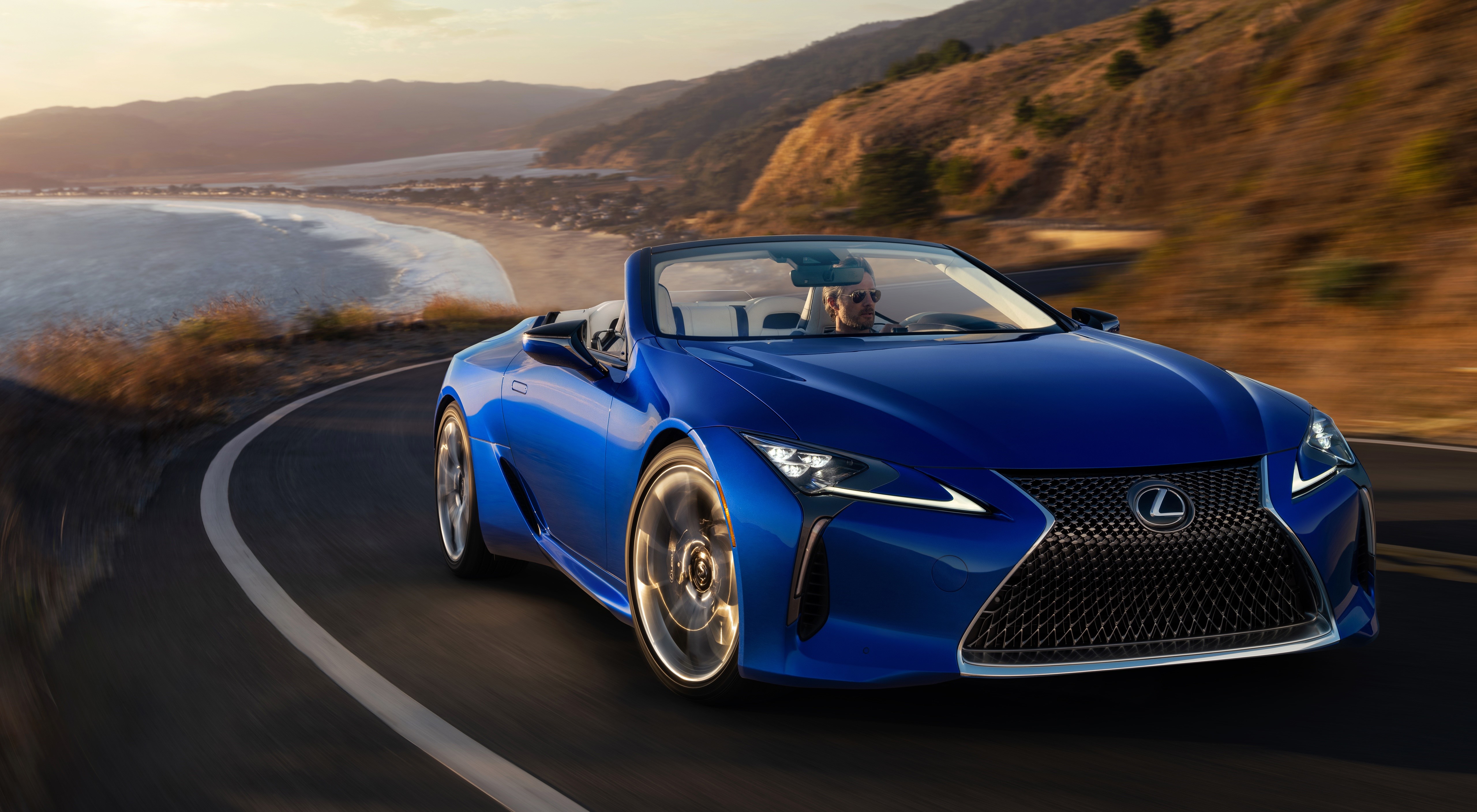 Blue 2020 Lexus LC 500 Convertible driving on a coastal road HD Wallpaper