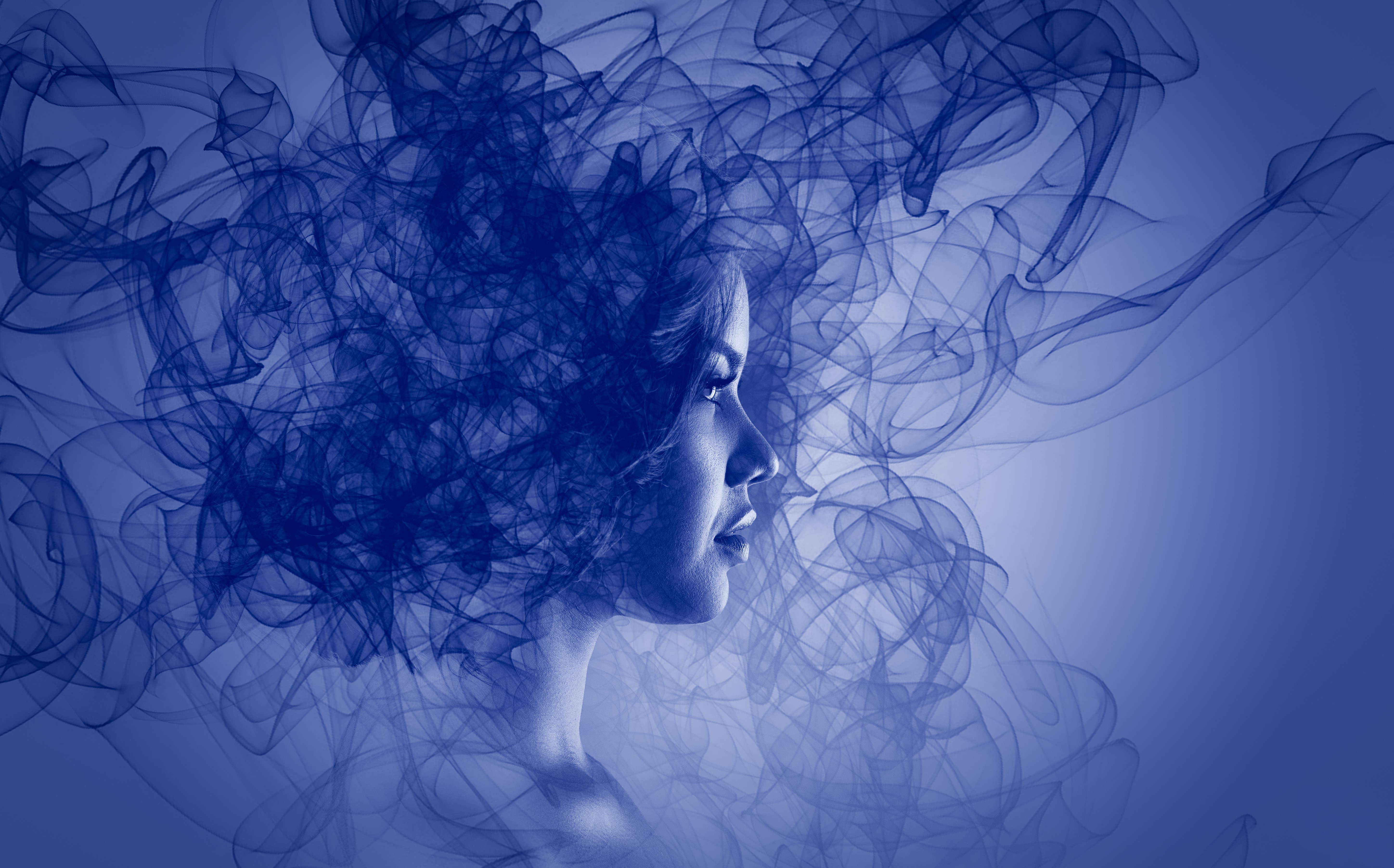 Woman's face emerging from blue smoke HD Wallpaper