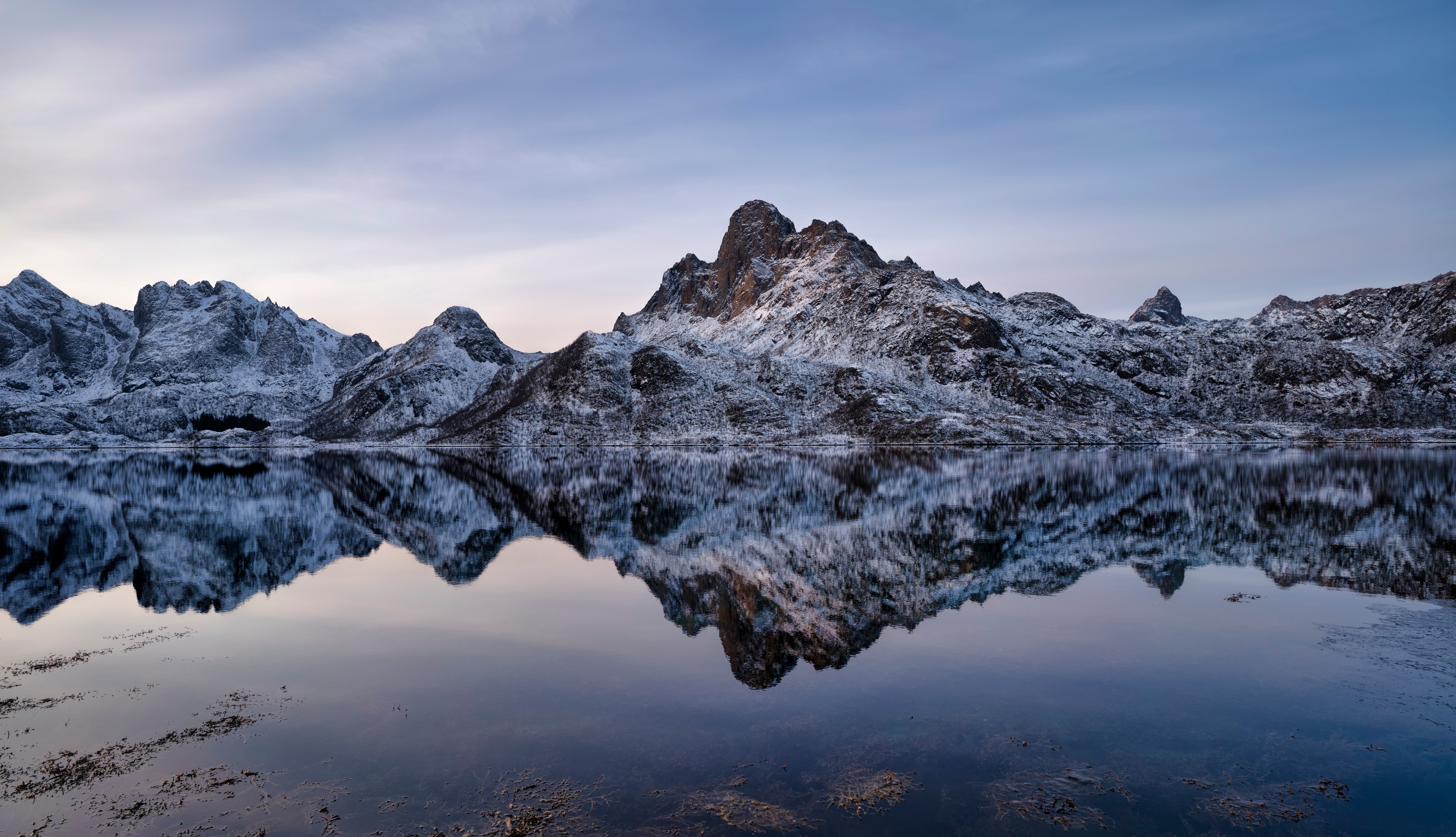 Snow-covered Lofoten mountains reflected in water HD Wallpaper