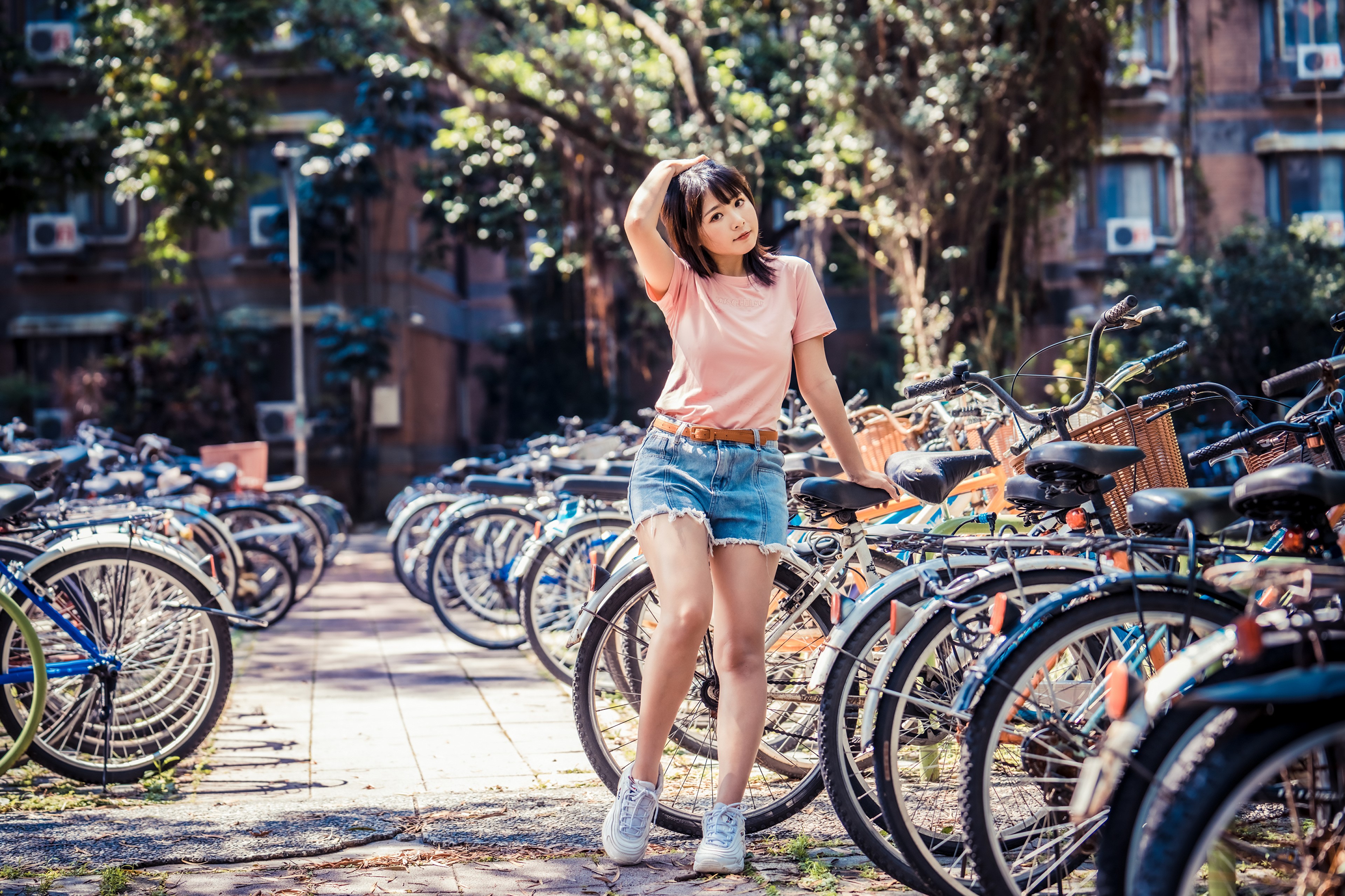 Asian woman in shorts and t-shirt with bicycles HD Wallpaper