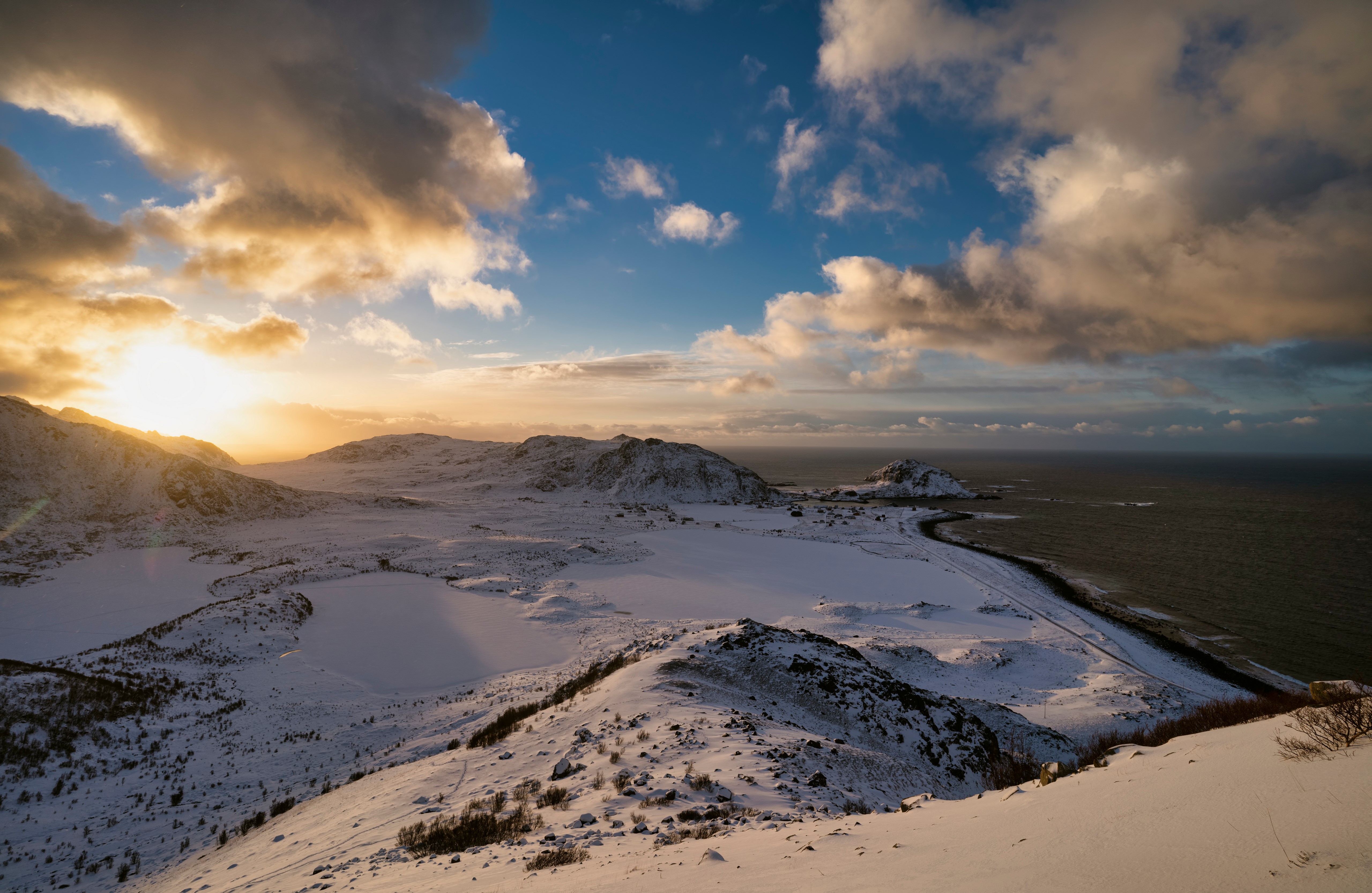 Snowy Lofoten Coastline with Mountains and Clouds HD Wallpaper