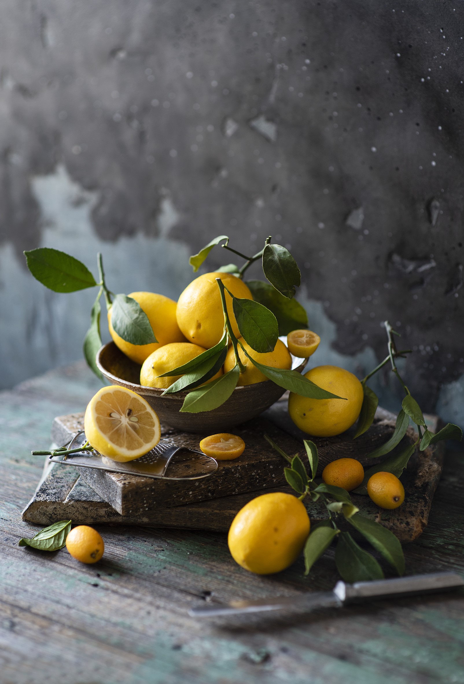 Lemons with branches on a rustic table HD Phone Wallpaper