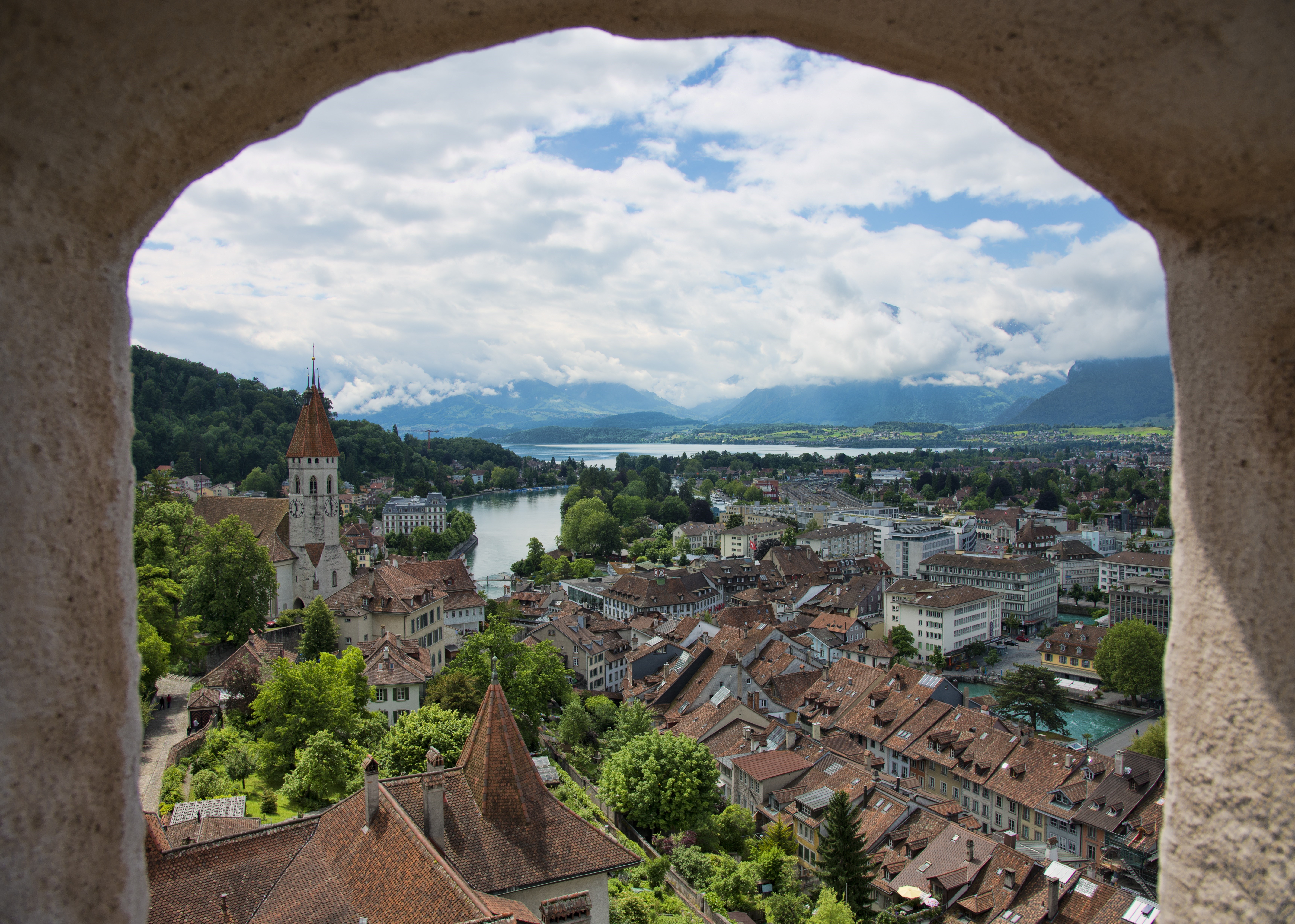 View of Thun, Switzerland with Lake Thun and mountains HD Wallpaper