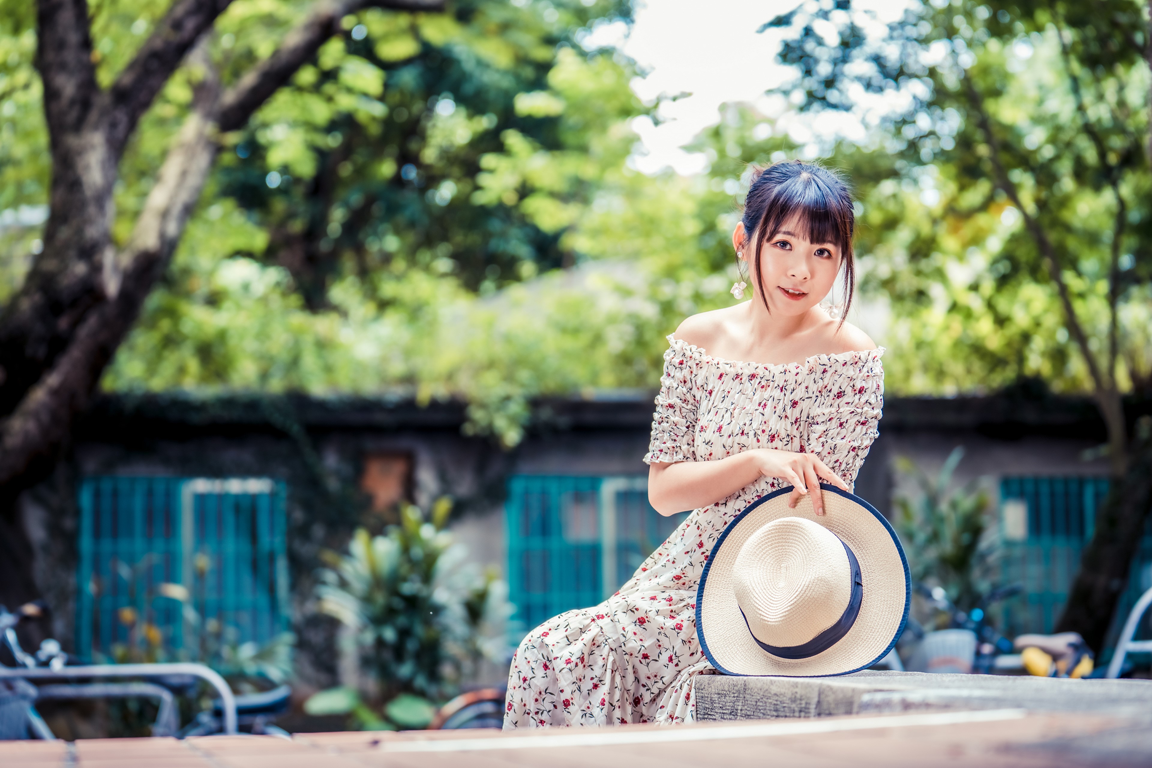 Asian woman in floral dress holding a hat HD Wallpaper