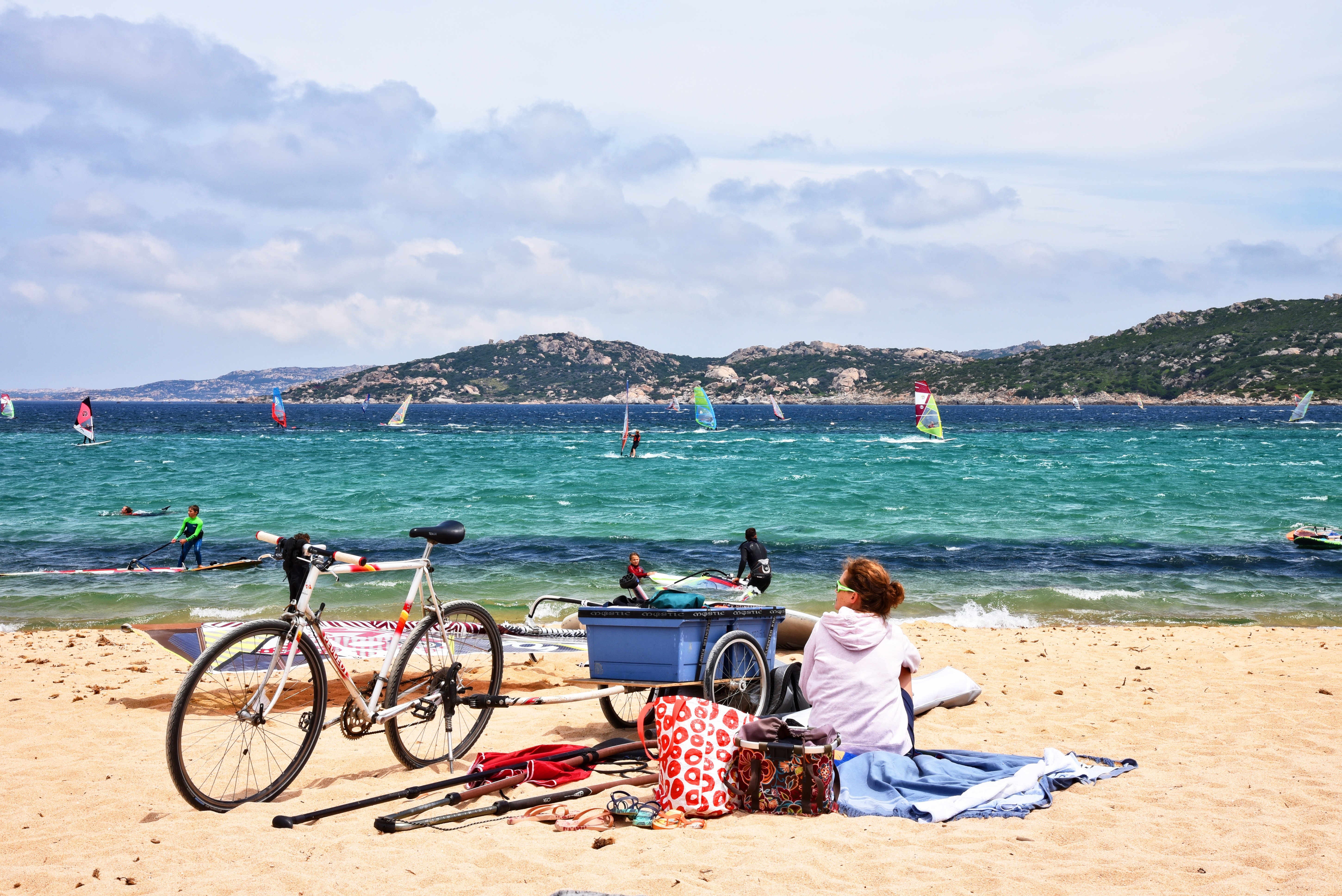 Windsurfing on a sunny day with a bicycle on the beach HD Wallpaper