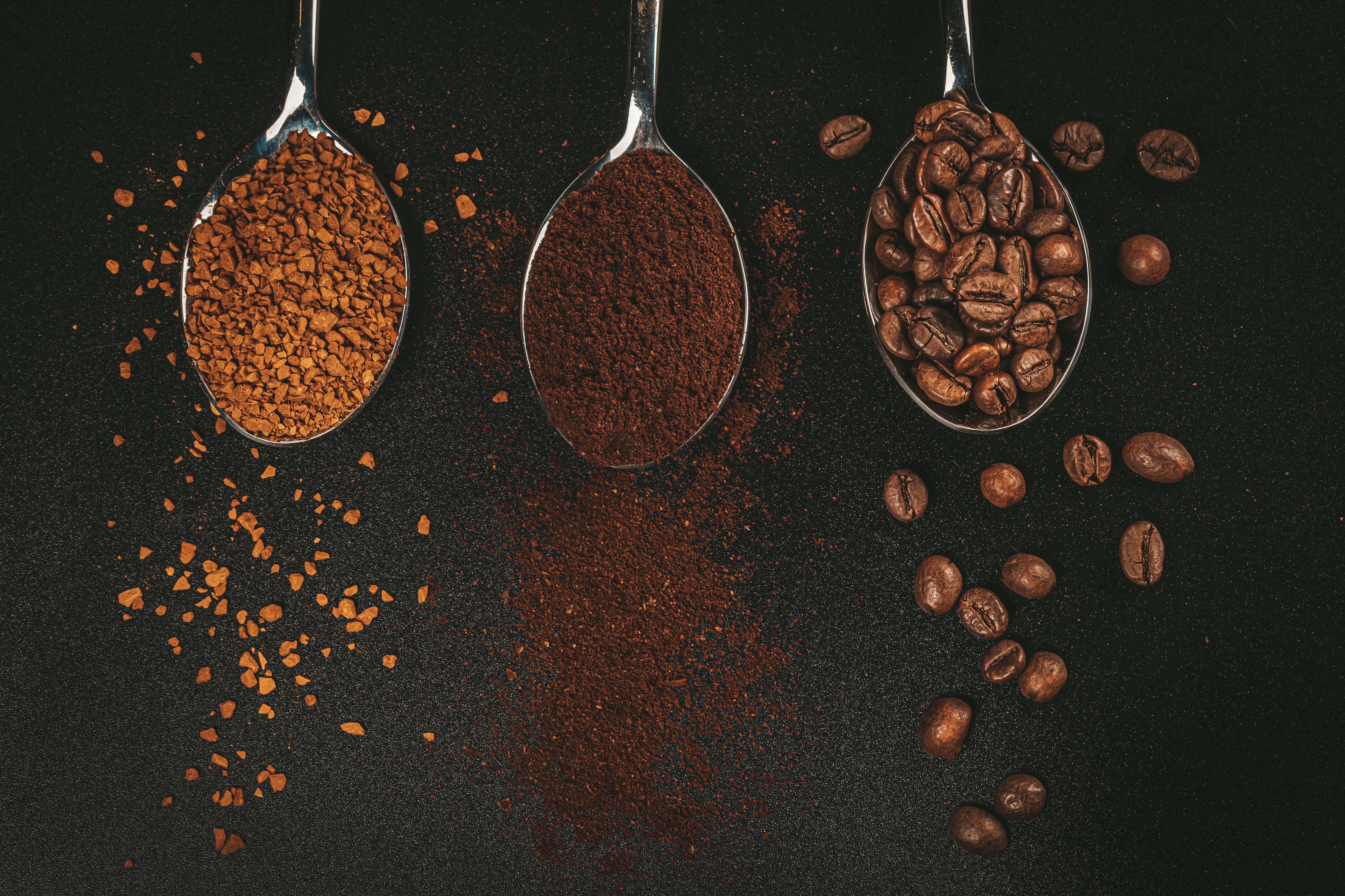 Three spoons with coffee: instant, ground, and beans HD Wallpaper